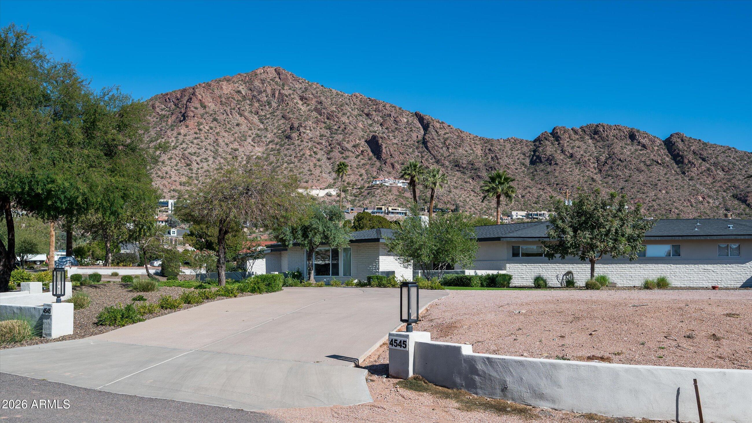 Gorgeous 1-acre homesite at the base of Camelback Mountain featuring picturesque head-to-tail mountain views and an exceptional opportunity to build or reimagine a luxury estate in one of the Valley's most coveted locations. The expansive lot offers breathtaking mountain vistas from nearly every angle and provides ample space for a custom residence, guest house, resort-style outdoor living and sport amenities. The property currently includes an existing residence and separate guest casita, offering flexibility for renovation, expansion, or redevelopment. With generous remaining lot space, there are endless possibilities to create a private desert retreat--add additional garages for the car enthusiast, install a pickleball or sport court, expand outdoor entertaining areas, or design the custom estate of your dreams. Enjoy the rare combination of 1-acre scale, iconic mountain views, and premier Arcadia setting, making this a truly exceptional land opportunity.