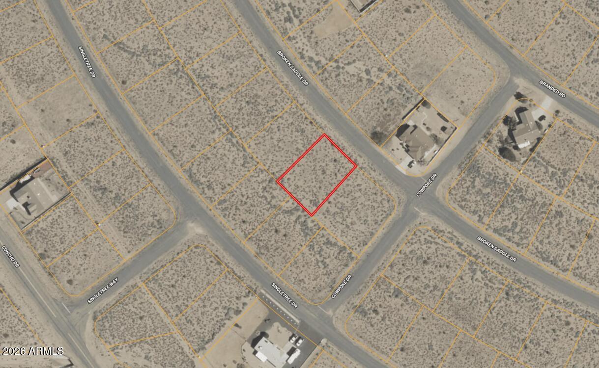 0.29 acres in Kingman with power at the lot line and a paved road out front. This lot sits on N Broken Saddle Dr in the Valle Vista subdivision, level, at 3,300 feet elevation in the high desert. Open sky, sparse scrub, and a quiet residential neighborhood around it. Owner will carry