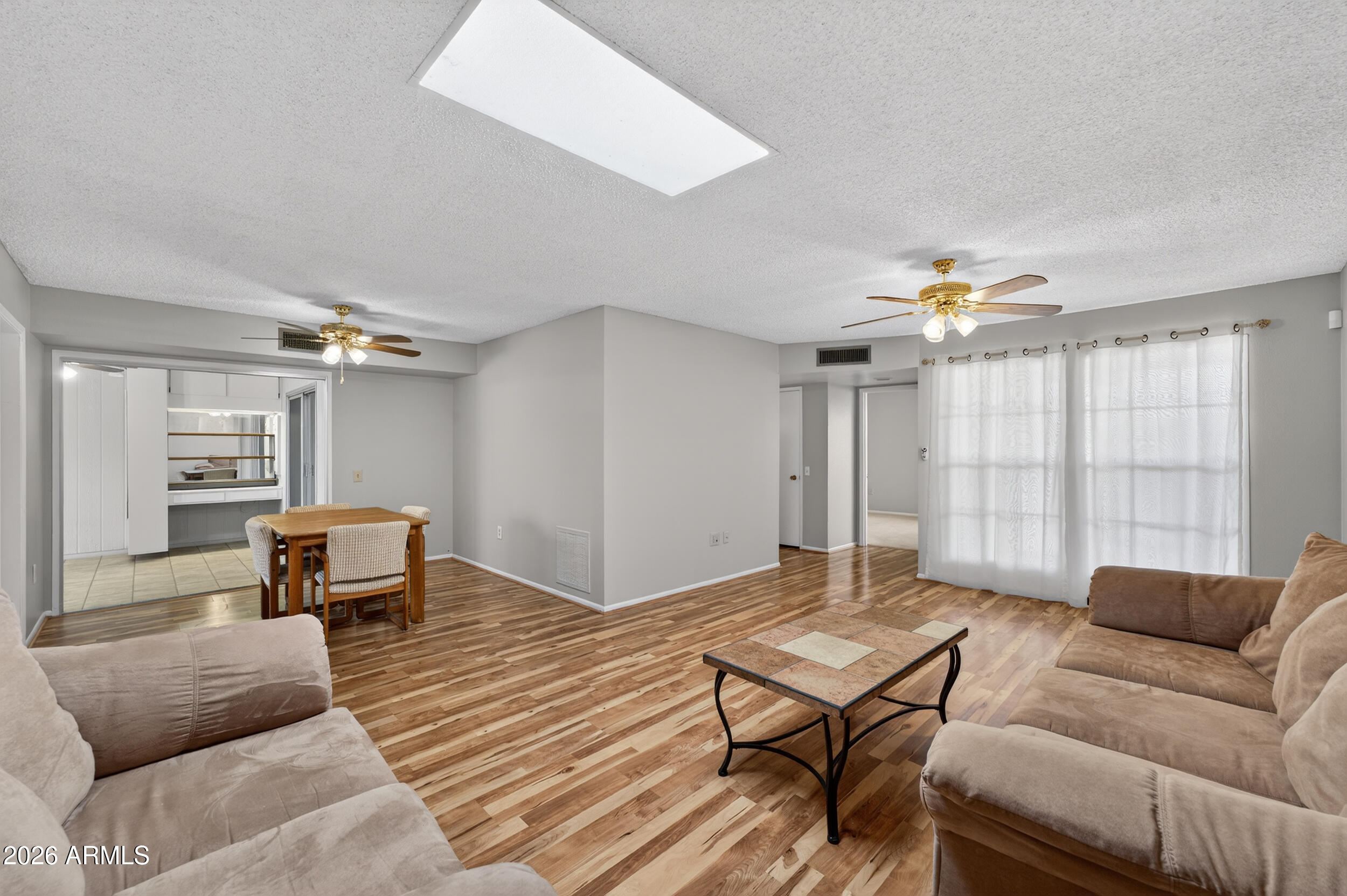 All the fun of Sun City West without the exterior maintenance! This reasonably priced HOA takes care of the exterior maintenance, roof repair & replacement, water, sewer, garbage, pest control & front yard maintenance - leaving you more time to play and enjoy all the amenities of this active, 55+ community. Home is freshly painted inside & a new A/C was put in June '25! Two generous sized bedrooms, wood looking floors, enclosed back patio plus a private back courtyard. One car garage w/storage and plenty of parking space for your guests behind the home. Come and find out why everyday feels like a vacation in ''Fun City West''!