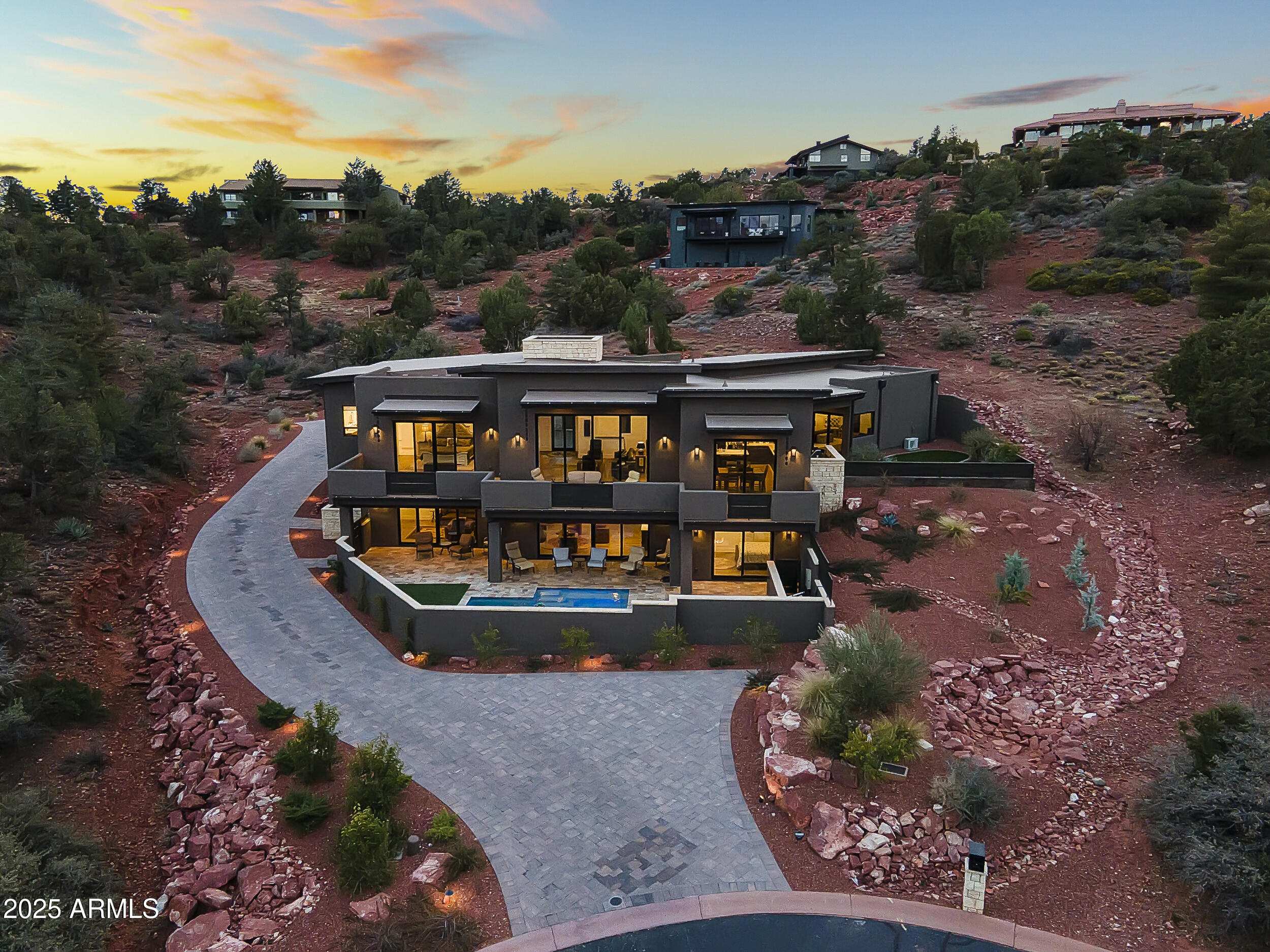 Exquisite contemporary residence with spectacular views of red rocks and evening starlit and city light views! Sedona custom home builder's own home. Located in desirable west Sedona in a gated subdivision. Private guest casita with separate entrance.  Open concept living with luxurious custom features thru out. Sparkling heated pool with water feature. Entertainers delight with plenty of outdoor living space plus romantic firepit seating area adjacent to the pool. Living room has expansive multi slide door. Two fireplaces. Huge .78 acre lot. Oversized 3 car garage. Security system and sonos sound. Media room could be a 5th bedroom.  Potential wine room space. Mechanical room can be converted into work out or hobby room not included in square footage.