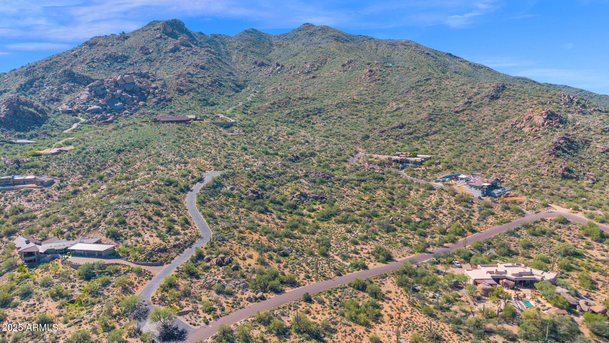 Discover Nighthawk on Black Mountain - a gated luxury enclave in Carefree, Arizona, envisioned by renowned desert architect Gerry Jones. This exclusive community currently has 6 custom homesites available for new construction. This 2.5 acre homesite captures the essence of desert living with panoramic views of Black Mountain, the Continental Mountains, and Carefree's twinkling city lights. The setting is rich with native Sonoran Desert vegetation, striking boulder formations, and complete privacy. Every homesite in Nighthawk was meticulously planned to harmonize with the mountain terrain, preserve natural beauty, and ensure optimal orientation and privacy between neighbors. Ideally located on the north side of Black Mountain, Nighthawk is just moments from the town center's fine dining, galleries, and shopping. With all utilities in place and the artistry a design legacy, this is a rare opportunity to build within one of Arizona's most scenic and sought-after luxury communities.
Experience desert architecture at its finest - where privacy, beauty, and authenticity come together in the heart of Carefree.

Additional Lots are Available, Inquire