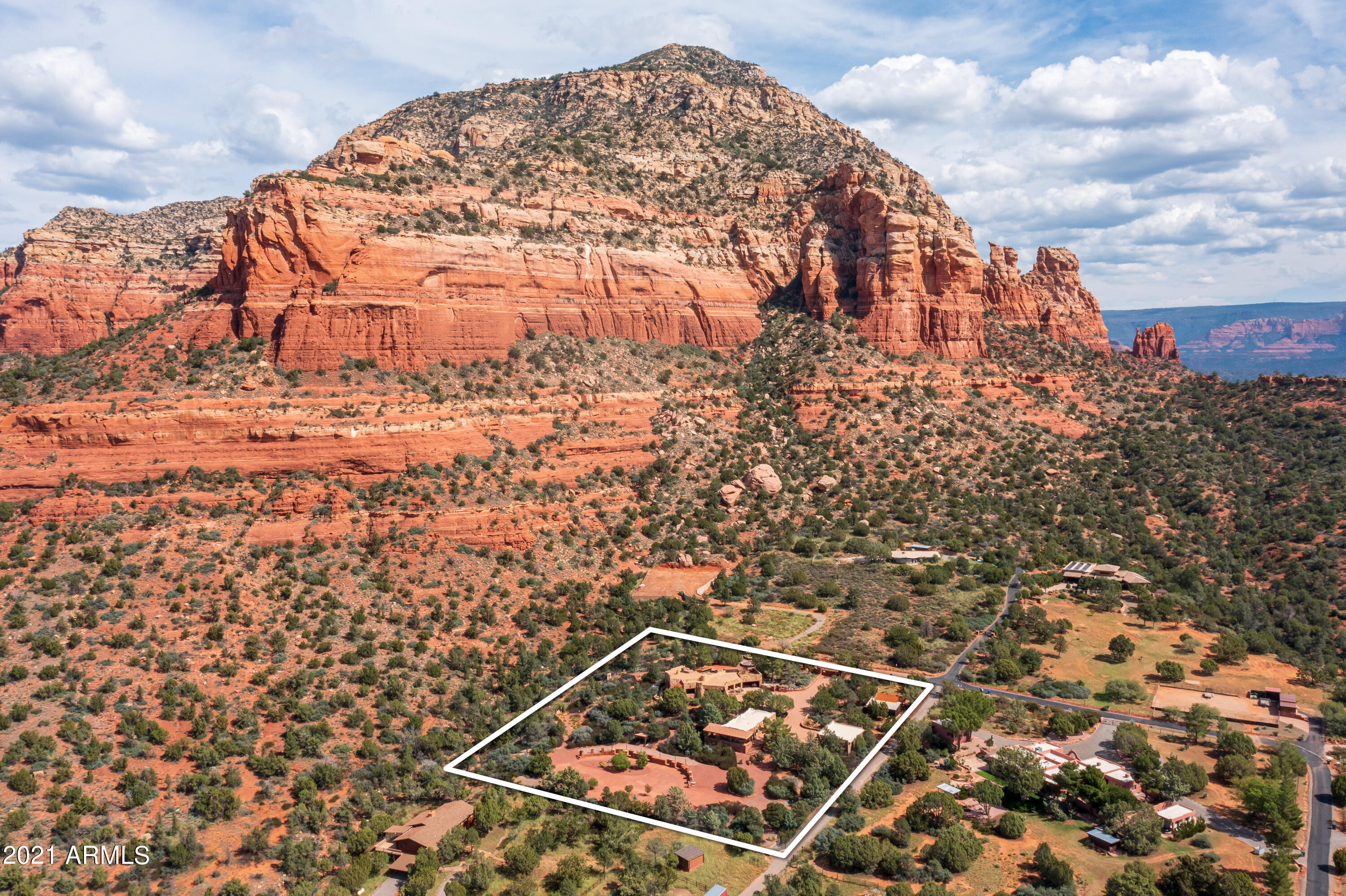 ''Boots First Ranch'' - A luxurious sanctuary with an abundance of rich history. The magnificent 2.56-acre property sits against national forest, beneath the infamous Lizard Head rock formation, offering unforgettable views. Remarkable and extensive renovations to the 1,848 SqFt., Main House; 1,456 SqFt., Guest House (2bd + Kitchenette + laundry+ living rm); 470 SqFt Bunk House (with AC), and exterior spaces. Enjoy year-round entertaining in your Arizona room, sit by your Kiva fireplace on your front lounging patio off the kitchen, or gather up your glasses & wine bottle and sit under the stars in your private spa (hot tub). The bunk house is utilized as a fitness room. Small orchard with ample room to build a pool in the arena area (formerly a horse arena). List of renovations in MLS docs