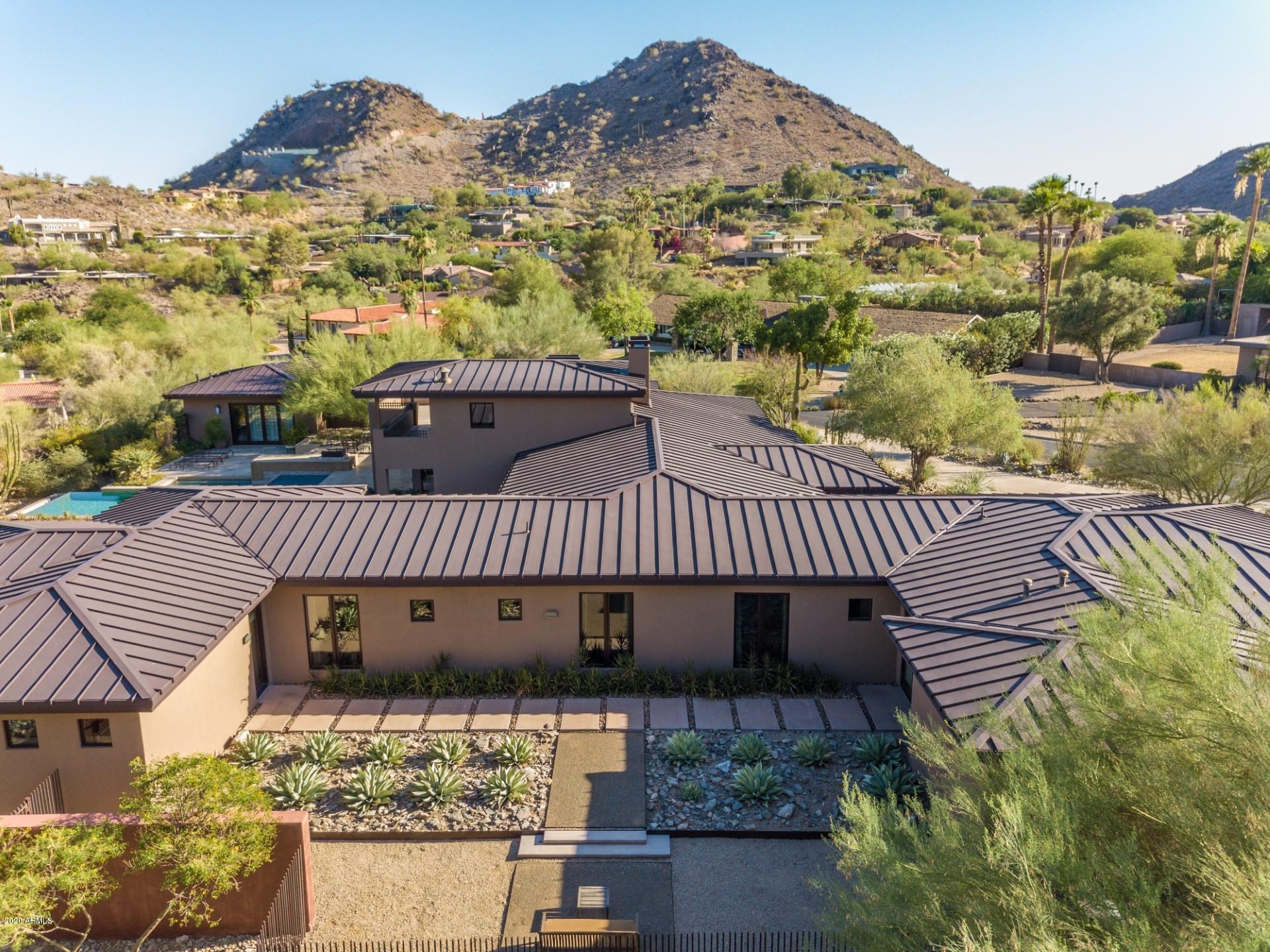 ''Dream-team'' (Christensen/Bromley) built, soft contemporary, mid-century feel home on elevated view lot in gated Clearwater Hills.  Featured in Phoenix Home and Garden Magazine this home creates an artistic blend of clean contemporary lines with an intimate soulful character as presented by the legendary iconic architect, George Christensen. The backyard is a private oasis featuring a zero-edge pool, spa, fire pit, outdoor shower and built-in BBQ. Sliding glass doors capture specimen gardens, charming patios and vistas from each room inviting the outdoors in.  Steel roof, & extraordinary designer finishes:  warm tones, thick wood doors & cabinetry, stone floors, gourmet kitchen-premium appliances/slab stone countertops opens to family room/game room.  Dual offices, home gym, detached guest house and large covered patio with turf grass area. 
Crestron one-touch lighting system, whole home Alexa sound system and state-of-the-art electronics.