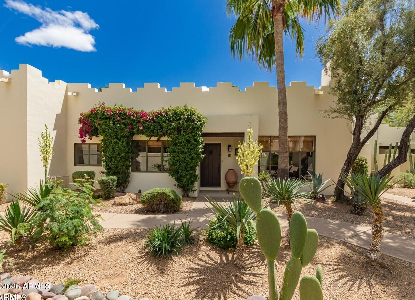 A truly special move-in-ready turnkey property in the iconic Casa Blanca community at the base of Camelback Mountain. Bathed in natural light and framed by mountain views, this highly coveted single-level residence blends timeless architecture with effortless 24-hour guard-gated lock-and-leave living. Thoughtfully designed with soaring 10-foot exposed beam ceilings, rich hickory flooring, a gas fireplace, European cabinetry, a Viking gas range, a Sub-Zero refrigerator, and strategically placed skylights, every detail reflects understated elegance and exceptional quality. The expansive 400-square-foot east-facing patio seamlessly extends the living space outdoors, creating the perfect setting for morning coffee, al fresco dining, or relaxing just steps from the community's main heated pool and the renowned rose garden. Set within 22 acres of lush, resort-style grounds, Casa Blanca offers three heated pools and spas, tennis and pickleball courts, meandering walking paths, and the peace of mind that comes with 24-hour guard-gated security. The flexible second bedroom easily serves as a guest suite or home office, while the home's premier location places you just minutes from hiking, golf, Scottsdale Fashion Square, and the dining and galleries of Old Town Scottsdale. This is more than a beautifully renovated home--it's a rare opportunity to enjoy one of Paradise Valley's most treasured communities and an exceptional lifestyle. Simply unpack and begin enjoying the timeless charm, resort-style amenities, and effortless lifestyle that make Casa Blanca one of Arizona's most sought-after communities