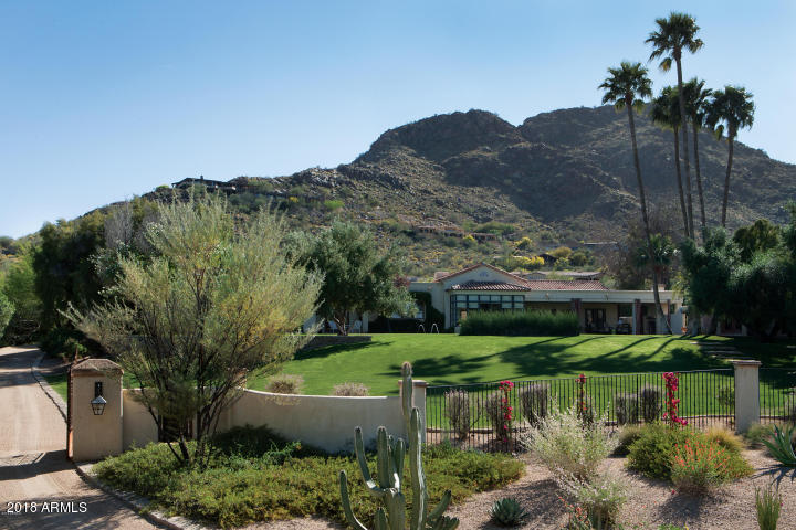 Designed with precision and care, this privately gated custom residence offers spectacular mountain and city light views from its secluded setting. Major reconstruction completed in 2005 by Mike Higgins, Architect, G.M. Hunt Builder, and Jim Smith Design Consultant.  The home overlooks the heated pool and a gently sloping lawn--one of the finest sites in PV. The attention to detail throughout the property reflects the utmost in thoughtful design. Exquisite custom finishes throughout. Custom plaster walls, antique limestone, marble, hand-hewn walnut floors are but a few of the special finishes. The oversized Master Suite includes antique doors which lead to an elegant Master Bath complete with double marble vanities and sinks.