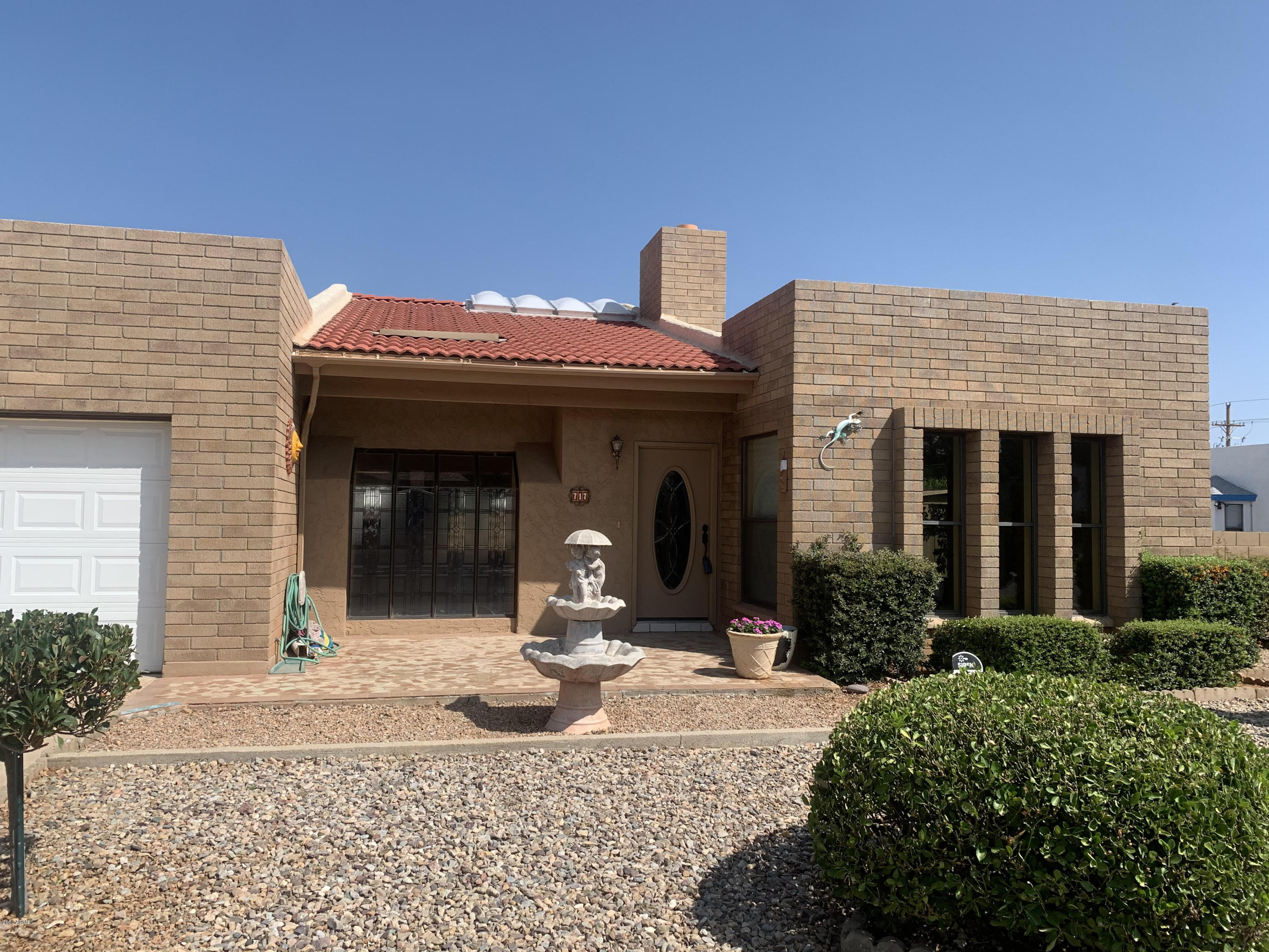 Beautiful upscale large family home with custom mosaic tile front porch. A 3 bedroom, split floorplan, separate laundry room with abundant storage cabinets, new garage door opener, 2 baths with elegant custom vanities.   Breakfast nook, living room, dining room, fireplace, den, 3 French doors leading to 500 sq foot heated Arizona Room. Lovely landscaped backyard with RV gate, shed with electricity and shady dog run with mature trees.  Newer low-e custom windows throughout, stainless steel appliances, pullout drawers, new ss range., touch-less faucet in kitchen, granite throughout. Custom neutral tile throughout and new laminate flooring in dining room. Roof recently inspected by licensed contractor and repairs completed. Show and sell this beauty!! Records show that existing square footage of 2300 ft does not include the 500 feet in Arizona Room, bringing total square feet to approx. 2800 ft.