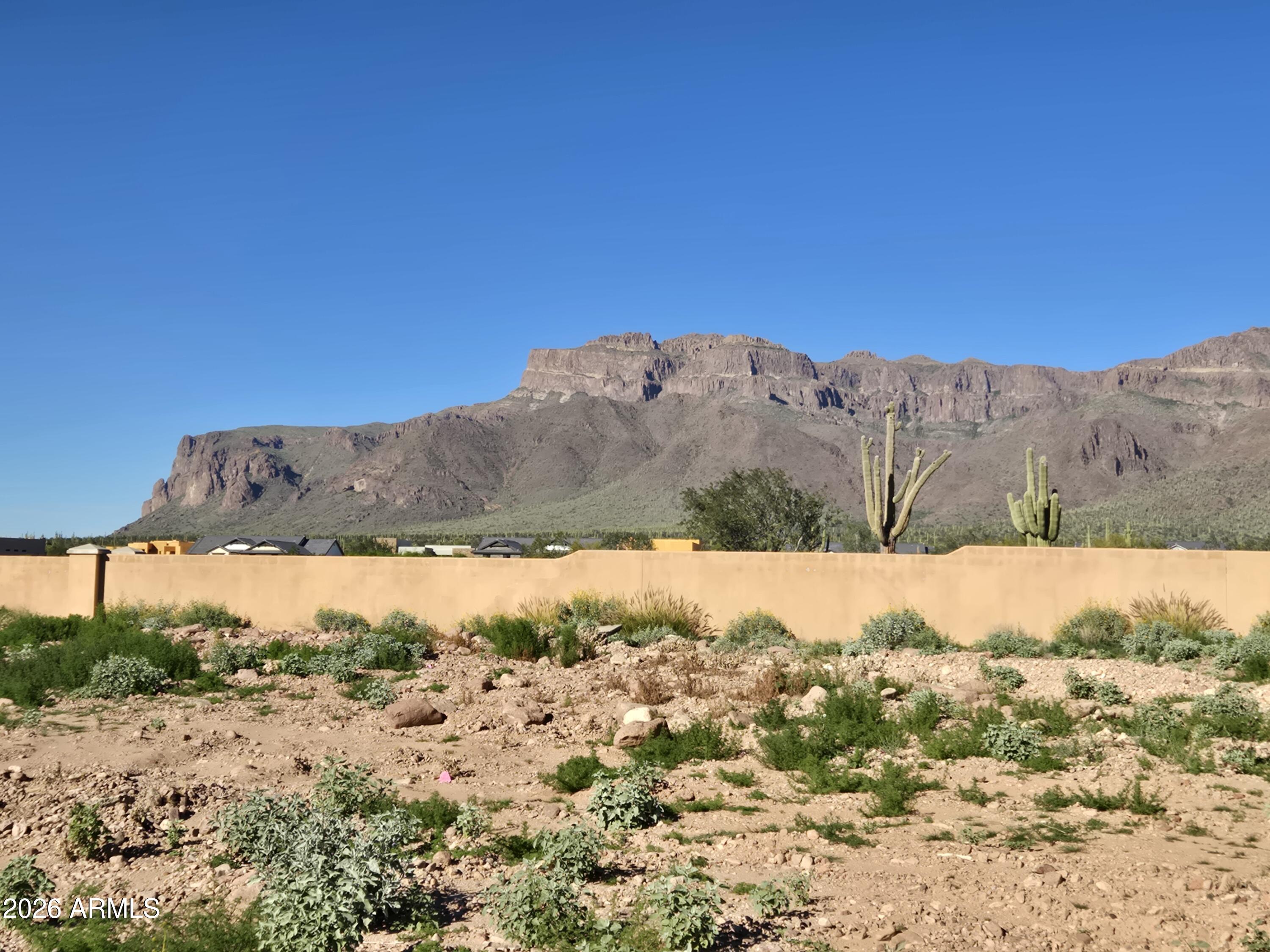 Fabulous SUPERSTITION MOUNTAIN views from this .63-acre homesite in Superstition Mountain Golf & Country Club in beautiful Gold Canyon, Arizona's best kept secret! This is an easy build, flat lot for your future dream home. There is no required build time, purchase soon and plan your home when you are ready. Minimum home size in Petroglyph Estates is 3000 sf. Private and serene setting awaits, two 18 hole premiere golf courses, fitness center, tennis and pickleball, bocce ball, nearby hiking, walking trails and more. When you enter these gates, it feels like home! Come see all this area has to offer, you'll be happy you did! Membership options are available under separate agreement.