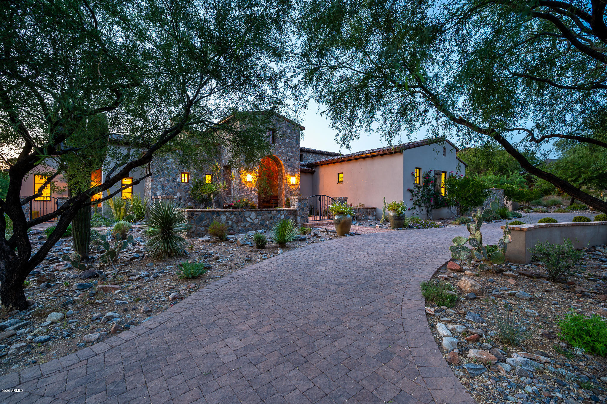 Stunning Rural Mediterranean home nestled in a quiet cul de sac, in the coveted Horseshoe Canyon gate of Silverleaf.  Built in 2013 by award winning Calvis Wyant Luxury Homes, this single level home offers a seamless flow of indoor and outdoor living.  The front foyer opens into a large living and dining room with windows that wrap around the courtyard featuring a firepit and fountain.  An open floor plan features a large Master Suite with fireplace, two large custom closets and sun lit master bathroom on one side, with three additional en suite bedrooms and bonus room on the other, and a fifth bedroom in the charming separate entry guest casita.  The main living areas are light and bright, with a beautifully appointed gourmet kitchen opening to a large family room. A second owner's entrance leads into a large laundry room and pantry with ample storage.  Large covered outdoor space with pool, spa, barbecue area and grass lawn.  All of this in a private setting, overlooking a wash with stunning sunset views.  Conveniently located in close proximity to the Silverleaf Clubhouse.