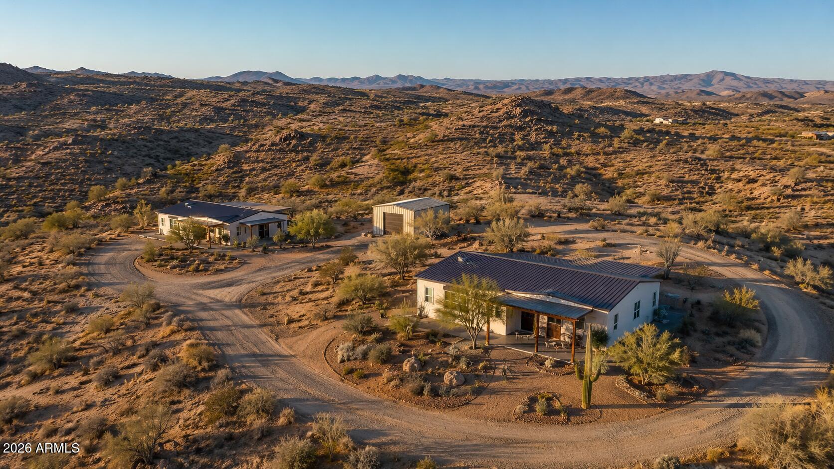 ALL OFFERS WELCOME. Own a brand-new home on 2.43 elevated acres with sweeping Arizona mountain views. Two ways to make it yours: (a) Lot + complete new-home package -- $498,900, featuring a brand-new 2,000 sq ft manufactured home, new well, new septic, power, foundation, and full installation turnkey, nothing left to do; or (b) Land only  $164,500, bring your own builder and vision.
Perched on a graded knoll with a circular drive already in place, this 2.43-acre parcel offers privacy, big views, and room to grow -- with potential to add a second residence and detached shop for a true two-home homestead or family compound (buyer to verify subdivision, septic, and utility feasibility with the county). Wide-open high-desert living with established neighbors nearby and the greater Goodyear /West Valley corridor within reach.

The complete home package price reflects land plus a full new-construction package -- new well, septic, power, foundation, and install all included -- and is subject to change; package can be tailored to your floor plan. Homes of this quality on acreage at this elevation don't last. Don't miss it.

Please note: This property is currently vacant land. One or more photos are conceptual renderings of a proposed home and do not depict existing structures. Finishes and final product may vary.