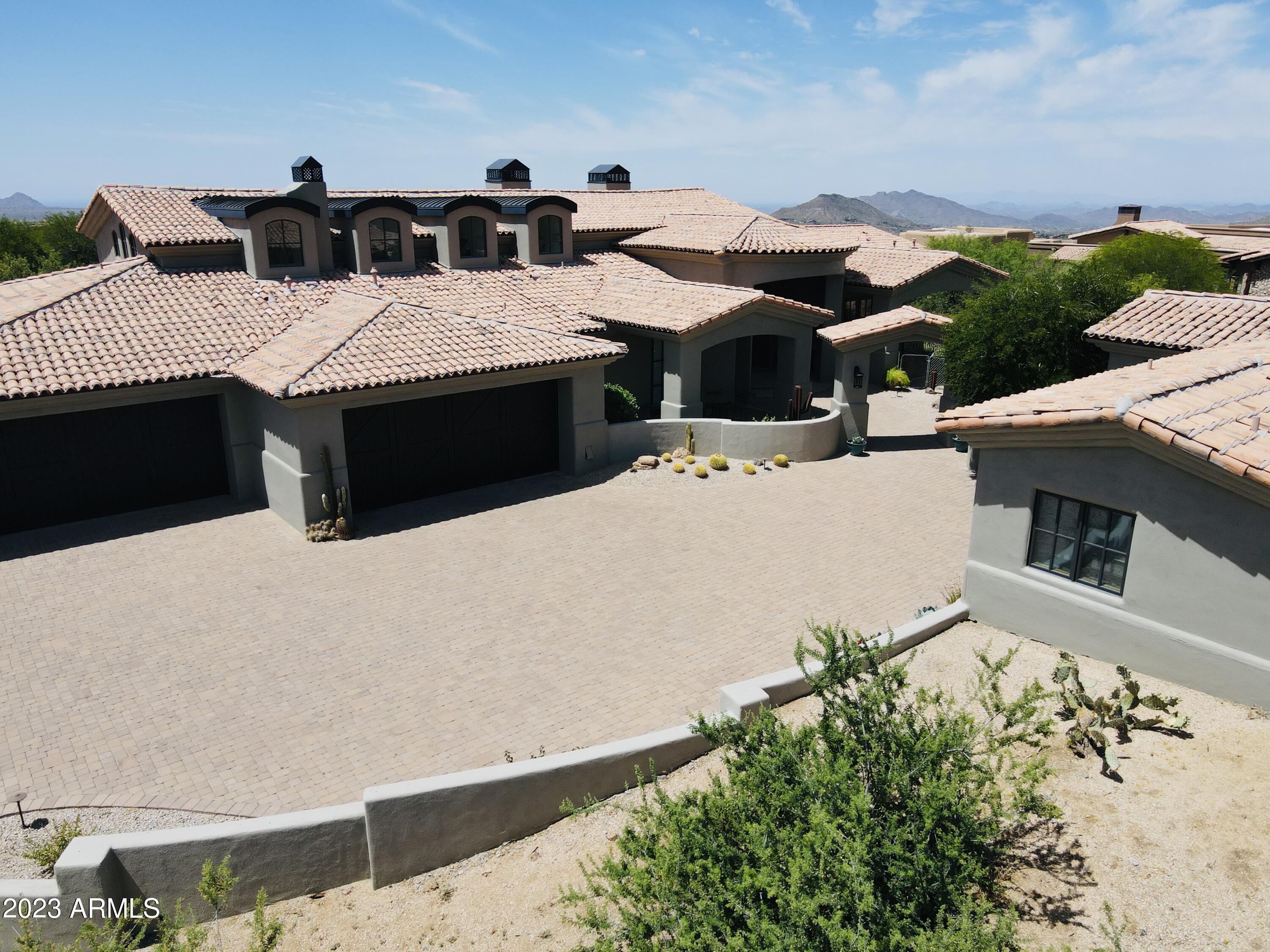 Desert Mountain Santa Barbara contemporary home in Apache Peak Village. NO STAIRS, and GOLF MEMBERSHIP TRANSFERABLE. 4 car garage, 5 total Bedrooms with separate entrance to Casita. A chef's Kitchen, walk-in wine room, expansive resort patio, great for entertaining. Large luxury master with a sitting room, private sunset patio, and his/her private toilet rooms and two large separate closets. 4 large ensuite bedrooms all with walk in closets and patios. Modern bright white interiors, Cantera stone details, impressive entry doors, Crestron system. Naturally lighted by architectural elements of high dormers and trusses, open ceilings. Private auto court. 7 golf courses & restaurants, spa/fitness/tennis, and endless activities.