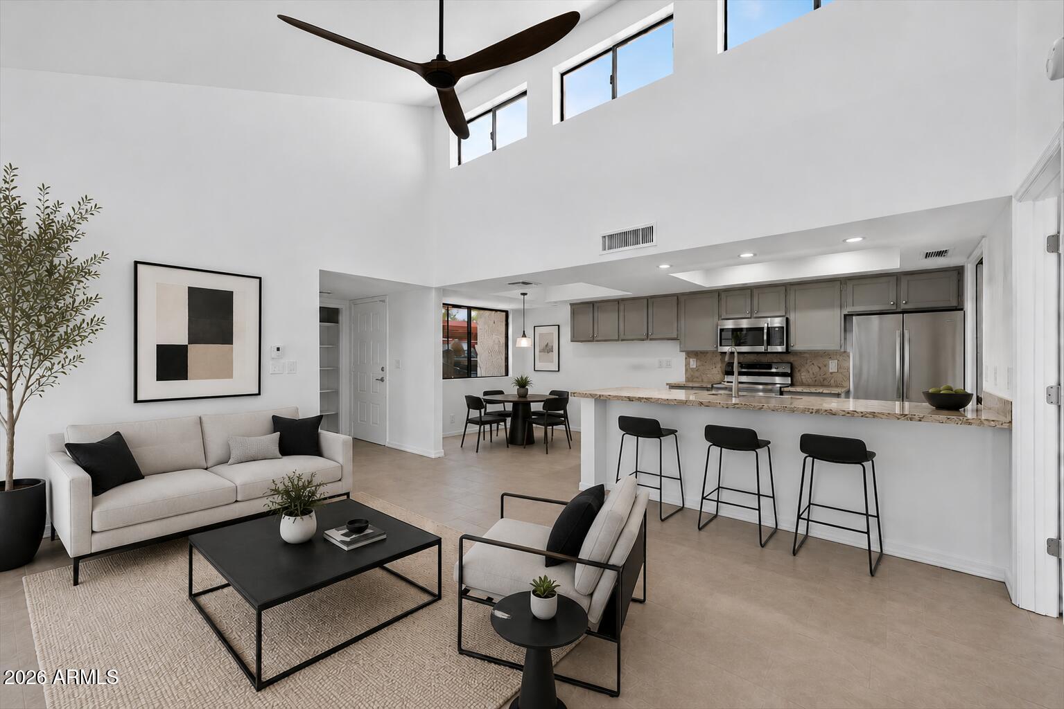Huge price adjustment on an exceptionally stylish Tempe condo close to Arizona State University! Modern single-level split bedroom floor plan with vaulted ceilings, clerestory windows & open layout filled with natural light. Fully updated with premium tile flooring, glass enclosed walk in shower in primary bath, granite countertops, stainless appliances, satin nickel fixtures & designer finishes throughout. Spacious private backyard features covered patio, mature orange tree & extra storage room. Inside laundry/pantry, covered parking beside front door & outstanding functional layout. One of the most impressive condos in the area -- discover it & make it yours before it is gone. :)