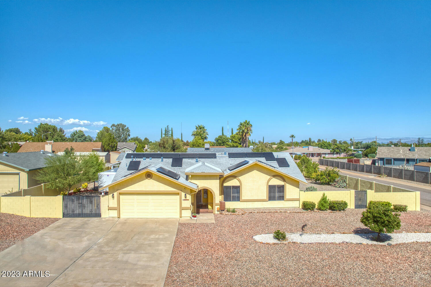 What an awesome home!! This 3 bedroom 2 bath property on a HUGE corner lot offers everything you could possibly want!  Mostly hard flooring throughout, updated appliances, living room with wood burning fireplace. updated dual pane windows, enormous fenced swimming pool that can be heated so your swim season is unlimited! Large Four Seasons sun room built in 2021 with lots of electrical outlets, can be utilized for so many options and entertaining!  2021 installed Solar that was recently bought outright to save you big money on electric bills, low maintenance front and back landscaping with enough room for your RV or toys! This home is perfect for those who love entertaining!  Lots this size aren't readily available for this price.  Call today!
