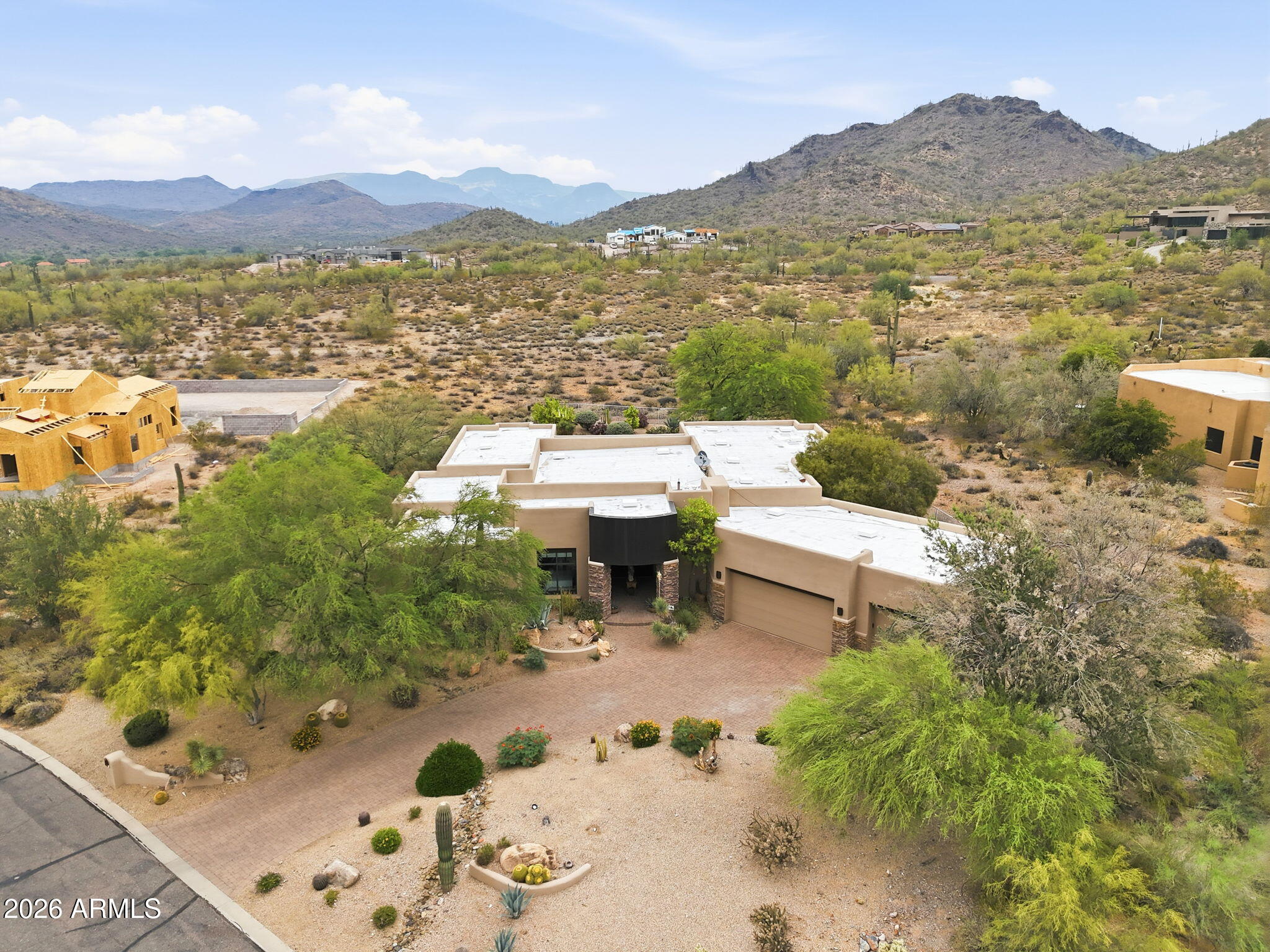 Luxury desert retreat on over an acre in Cave Creek with stunning mountain views. This custom home features a split floor plan with 4 ensuite bedrooms, spacious living areas, and high-end finishes throughout. Gourmet kitchen opens to great room, perfect for entertaining. Automated retractable glass wall creates seamless indoor/outdoor living to an oversized covered patio. Resort-style backyard includes heated pool, spa, outdoor kitchen, and multiple seating areas. Primary suite offers spa-like bath with soaking tub and dual walk-in closets. Additional highlights include smart home system, private theater, travertine flooring, custom cabinetry, and 3-car climate-controlled garage. Premium homesite offering privacy and breathtaking Sonoran Desert surroundings. This is the perfect spot for an AirB&B which it has been used for the past 3 years and is very successful. Home was originally built for a Microsoft exec, so the home has GI panels controlling the lighting, shades, climate, media & security. You will fall in love with the 20ft. Livingroom window wall door opening up to your backyard sanctuary to include an outdoor kitchen! So much more-You don't want to miss this one!