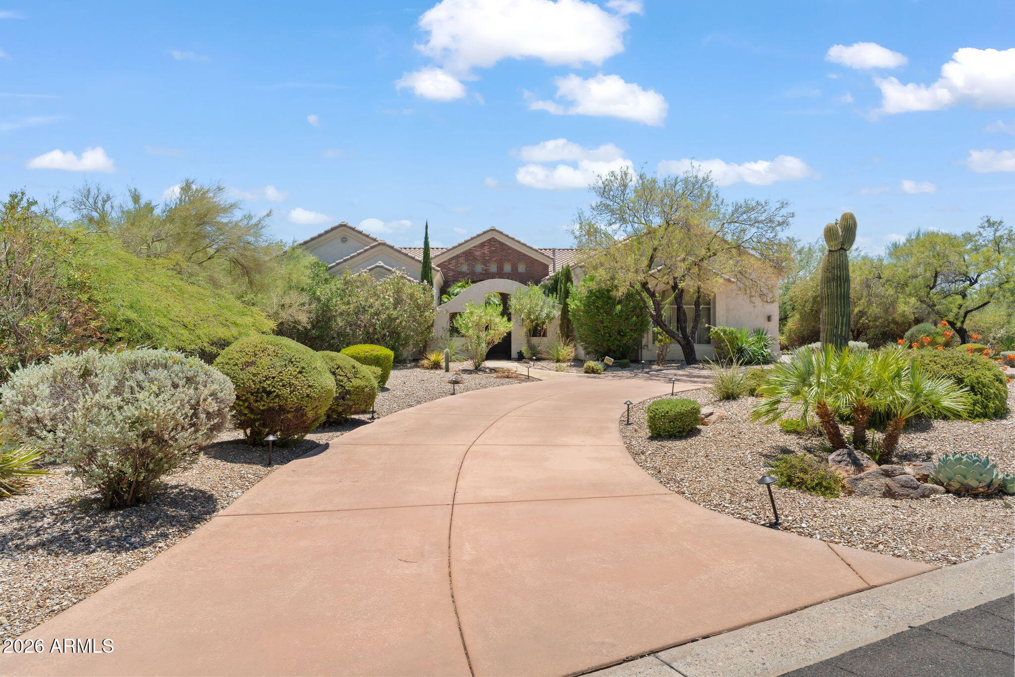 Discover desert living in this exceptional North Scottsdale estate, situated on a private corner acre lot on a quiet street shared by only 7 homes, with no HOA. Circular driveway and inviting courtyard, create a warm welcome. Designed for both elegant entertaining and everyday comfort, this 4-bedroom, 3-bath residence showcases a beautifully upgraded chef's kitchen featuring a dramatic waterfall-edge island, premium high-end appliances, custom finishes, and generous workspace. The expansive primary suite is a true retreat, offering a spa-inspired bath and abundant closet space. Step outside to your own private backyard sanctuary, where a sparkling pool is surrounded by mature landscaping, creating the perfect setting for relaxing, entertaining, or enjoying Arizona's year-round sunshine.