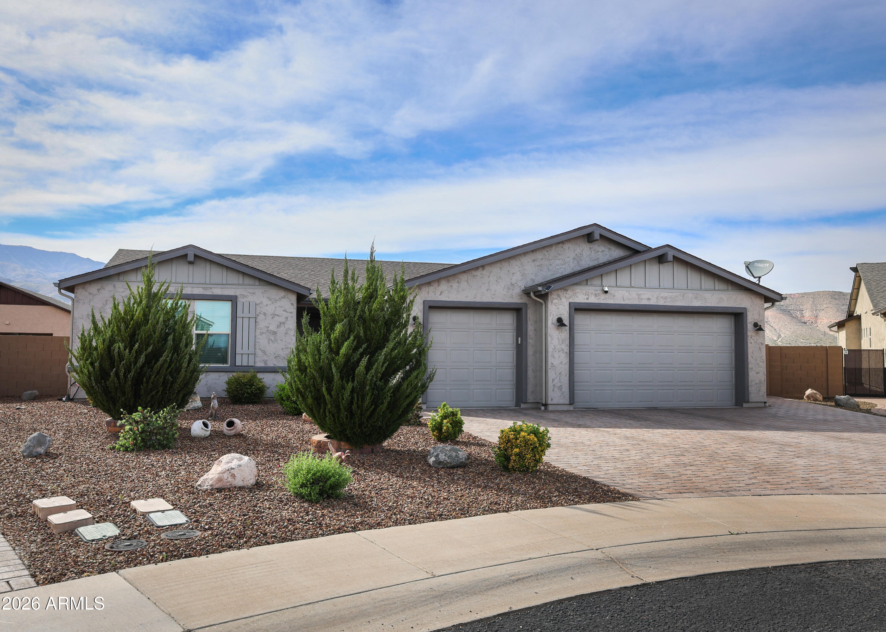 Welcome to your dream home. This stunning 2021-built gem is situated on a peaceful cul-de-sac, offering an exceptional blend of beauty, function, and privacy with breathtaking views of Mingus Mountain, Jerome, and Sycamore Canyon. Additionally, ownership includes access to the gorgeous Mountain Gate Park.
This 1,954 sq. ft. residence sits on a meticulously landscaped 0.21-acre lot featuring a private garden and raised planter boxes. Inside, an inviting open-concept floor plan is flooded with natural light and adorned with Hunter Douglas custom window coverings, creating a seamless flow perfect for both entertaining and quiet relaxation. 
From long kitchen cabinets with soft close hinges to partitioned yard areas to a dog door, key features and recent upgrades include: - New Whirlpool Microwave Oven and Dishwasher.
- Outdoor Living: An extended patio with a cozy fire pit, ideal for evenings under the stars. When temperatures rise, a roll down patio blind makes the patio a shady retreat on bright sunny days.
- Luxury Finishes: Fully repainted interior with Sherwin Williams Emerald in January 2026, including doors, new granite counter top and backsplash in bathrooms, dimmable can lights throughout, new lighting in kitchen and bathrooms, new Kohler fixtures, Kohler Tip Toe sink stoppers and metal faceplate outlet covers.
- Sustainability: Equipped with 13 solar panels, a clean air exchanger, and an energy-efficient build.
- Curb Appeal: A fresh 2024 Sherwin-Williams Duration exterior paint job.
- Storage: A four-foot extended, 3-car garage with eight-foot-tall doors to accommodate all your toys.  Gladiator locking storage cabinets are hung and ready to use.

With upgrades throughout that provide the feel of a custom retreat, this Mountain Gate beauty is ready to welcome you home. 

Washer/Dryer may be considered with the Purchase Offer.
Vacuum hanging in the garage is not included.
Outdoor fireplace insert the backyard is not included.

Please allow for 2 hours advance notice on showing requests. List agent to accompany. Contact agent to show.