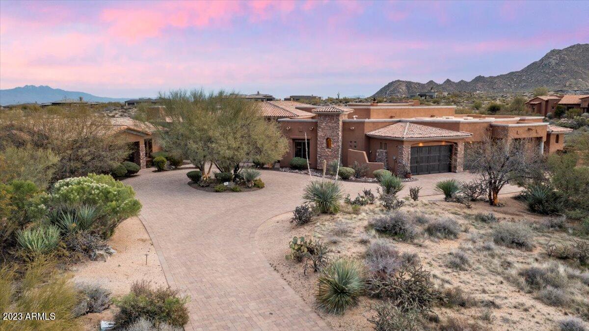 This Luxor-built estate in Sonoran Crest sits on over 2 acres with extraordinary views of the McDowell Mountains! A private motor-court guides you through the grounds of this lush estate with 6 beds/7 baths and a huge detached casita! Iron doors open into the grand entry & living room with those magnificent views. Huge primary ensuite with jet-tub, walk in shower, & private office/workout room w french doors to private patio. Beautiful office next to owner-suite and 4 large secondary ensuite bedrooms.  Guest house includes full kitchen, dinette, bedroom and living area. Chef-lovers' kitchen includes gas Wolf cooktop and 2 ovens, 2 dishwashers, Miele coffee machine, sub-zero refrigerators, warming drawer and huge island! Entertainers will enjoy the large wet bar with access to the temperature-controlled wine cellar. Large family room with floor-to-ceiling windows and sliding pocket doors with views of the backyard oasis. Enjoy the privacy in your backyard with heated pool, spa, built-in barbecue, outdoor heaters, putting green, gas fireplace, multiple seating areas and rooftop access to 360 views of the mountains!  Enjoy all North Scottsdale has to offer with quick access to miles of hiking/biking trails, golf-courses and fine dining.  Floor plan and property map in document section.