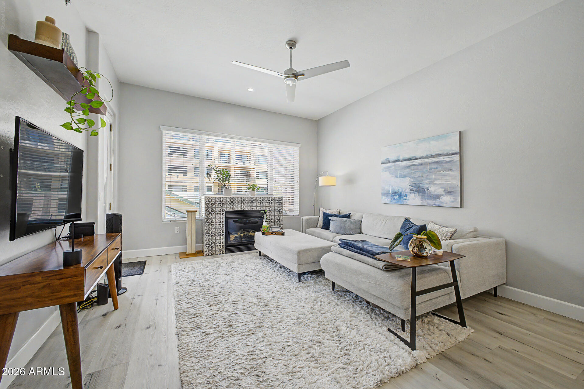 Enjoy convenient urban living in this beautifully remodeled 2-bedroom, 2-bath condo overlooking the community's lush, landscaped central courtyard. Light, bright, and inviting, this home blends modern updates with a warm, comfortable feel, featuring a neutral color palette, luxury vinyl plank flooring, and abundant natural light throughout. The stylish kitchen is designed to impress with quartz countertops, crisp white cabinetry, high-end GE Café stainless steel appliances, a 6-burner gas range, and a striking decorative tile backsplash. Seamlessly connected to the dining and living areas, the open layout is ideal for both everyday living and effortless entertaining, anchored by a cozy gas fireplace that adds warmth and character to the space. The spacious primary suite serves as a relaxing retreat with private balcony access and a spa-inspired ensuite bath showcasing designer tilework, a soaking tub highlighted by an elegant chandelier, and a beautifully tiled walk-in shower. Thoughtfully designed, this calming space offers a true sense of comfort and escape at the end of the day. A second private balcony extends your living space outdoors, while an oversized laundry room and assigned underground parking add everyday convenience. Residents enjoy resort-style amenities including a pool, spa, and fitness center, all within a well-maintained community. Ideally located across from the Heard Museum and just steps from the light rail, you'll have easy access to downtown Phoenix, dining, museums, entertainment, and sporting events.