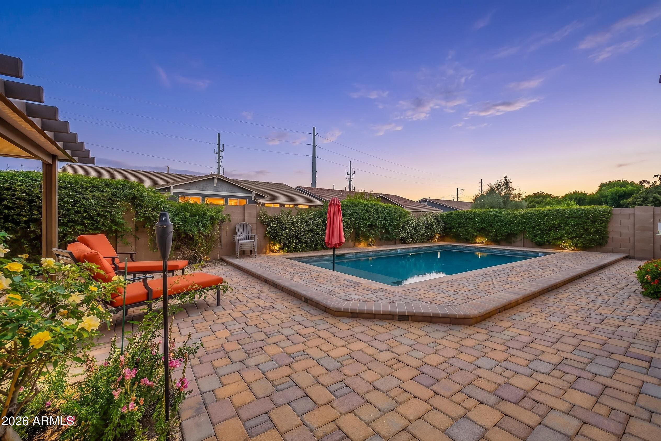 Welcome to the Desert Place area in the highly desired Morrison Ranch community, where charm and comfort come together in this bright and move-in ready home filled with upgrades throughout. A cozy front porch and beautiful plantation shutters add warmth and style as you step into a light and open entry with a den, family room, and a private courtyard that brings in natural light and fresh air. The formal dining space flows into a large living room with wide atrium sliding doors that open to the back patio and sparkling pool view, creating easy indoor and outdoor living. The kitchen is stunning with rich cabinetry, granite countertops, an extended island, gas cooktop, wall ovens, tile backsplash, butler's pantry, and a spacious walk-in pantry, all finished with farmhouse pendant lighting over the island and dining nook. The primary suite offers a relaxing retreat with dual sinks, a tiled walk-in shower, soaking tub, and large walk-in closets with extra linen storage. A separate living space with two bedrooms and a full bath is ideal for guests or multi-gen living. The backyard is an entertainer's dream with pavers, a pergola ramada, built-in BBQ island, pebble tech pool, lush desert landscaping, jasmine flowers, and a papaya tree, plus an RV gate and extra storage space. Added features include rain gutters, extra insulation, an insulated garage, tankless hot water heater, reverse osmosis system, and water softener, all set in a beautiful community with tree lined streets, parks, lakes, and walking paths.