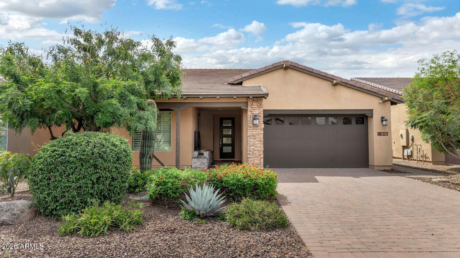 Luxury meets low-maintenance living in Trilogy at Verde River! This stunning single-level residence showcases exceptional curb appeal with a paver driveway, stacked-stone exterior accents, and a warm private courtyard entry. Inside, the sought-after Great Room design is elevated with designer finishes, wood-look tile flooring, plantation shutters, custom accent walls, and seamless indoor/outdoor living through expansive sliding glass doors. The showpiece temperature-controlled glass wine display with LED lighting creates an unforgettable focal point, while the gourmet kitchen features quartz countertops, stainless steel appliances, upgraded cabinetry, decorative backsplash, and under-cabinet lighting. The spacious primary retreat offers a spa-inspired bath with dual vanities and oversized walk-in shower, while guest spaces are equally refined and inviting. Step outside to your private resort-style backyard complete with covered patio, built-in BBQ island, fire feature, manicured landscaping, and stylish entertaining spaces designed for Arizona evenings. Enjoy world-class amenities including pools, fitness center, pickleball, tennis, bocce, dining, spa services, social events, and miles of hiking/biking trails. Optional golf membership provides access to the Tom Lehman-inspired championship course. Minutes from Scottsdale, yet surrounded by Sonoran Desert beauty.