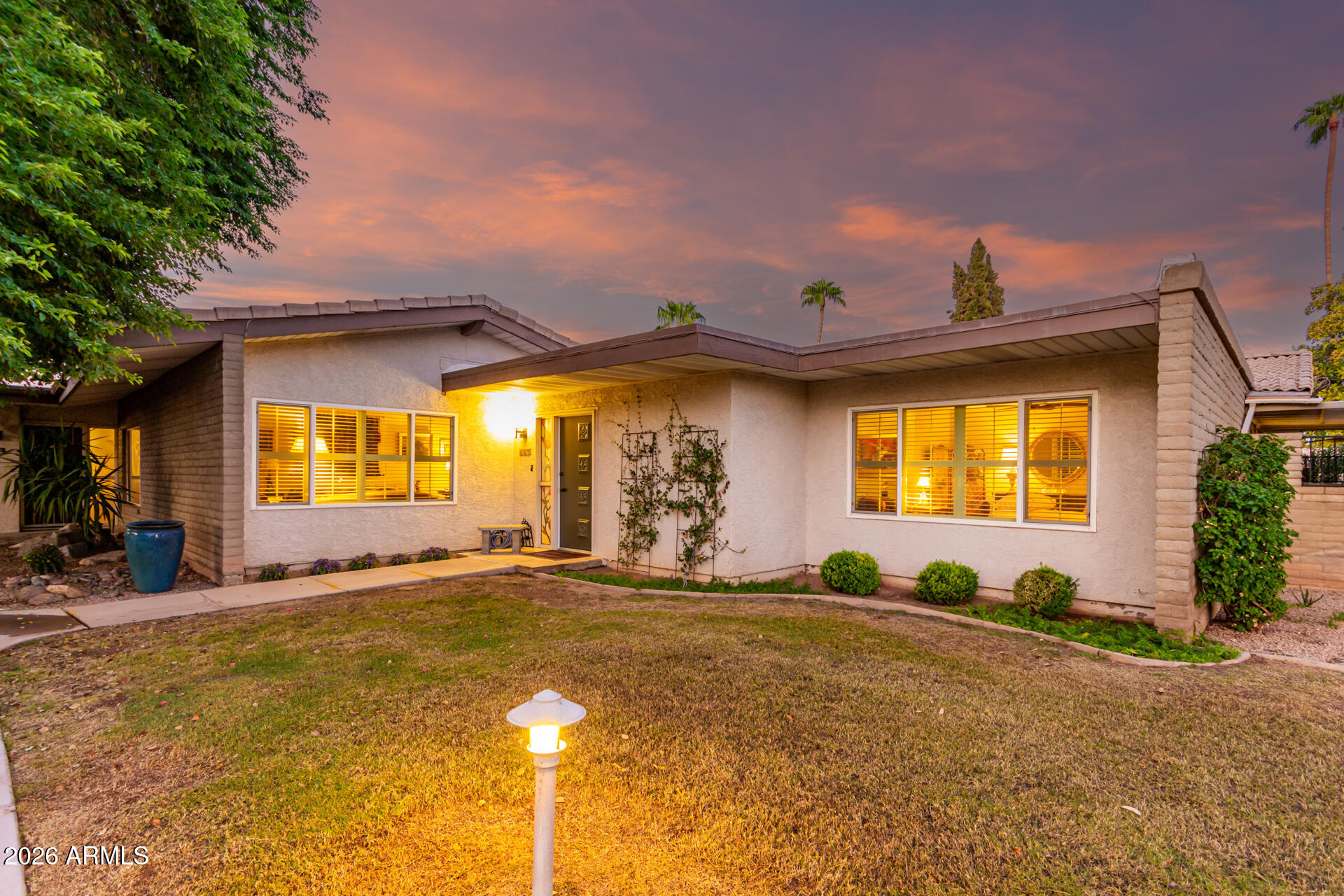 If you're looking for something with real personality, this is it. This beautifully designed one-bedroom home lives large and comfortably on one level. Vaulted living-room ceilings create a bright, open feel, while thoughtful designer touches add warmth from the moment you walk in. Parking is conveniently located close to the unit, and Camelback Mountain can be enjoyed from within the community. The guard-gated setting feels like a resort, with residents enjoying a pool, spa, fitness center, private restaurant, hair salon, library, and lush, manicured grounds. Located just across from Scottsdale Fashion Square and minutes to Old Town's dining, shopping, and art scene—this home offers true lock-and-leave living in the heart of Scottsdale.