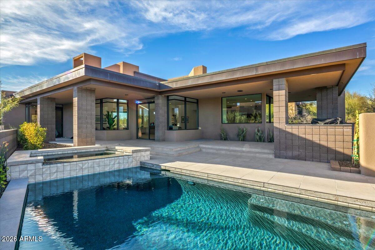 GOLF MEMBERSHIP AVAILABLE! Exquisitely reimagined with refined modern design, this exceptional residence offers a sophisticated living experience within the prestigious Desert Mountain community. Bathed in natural light, the thoughtfully curated interior features expansive windows, rich wood flooring, and an open, seamless floor plan ideal for both everyday living and elegant entertaining. The chef's kitchen is a statement of form and function, appointed with high-end finishes, premium appliances, and sleek modern lines. Perfectly positioned along the 7th hole of the Apache Golf Course, the home captures serene desert and fairway views, offering privacy, beauty, and an elevated lifestyle in one of Scottsdale's most sought-after settings.