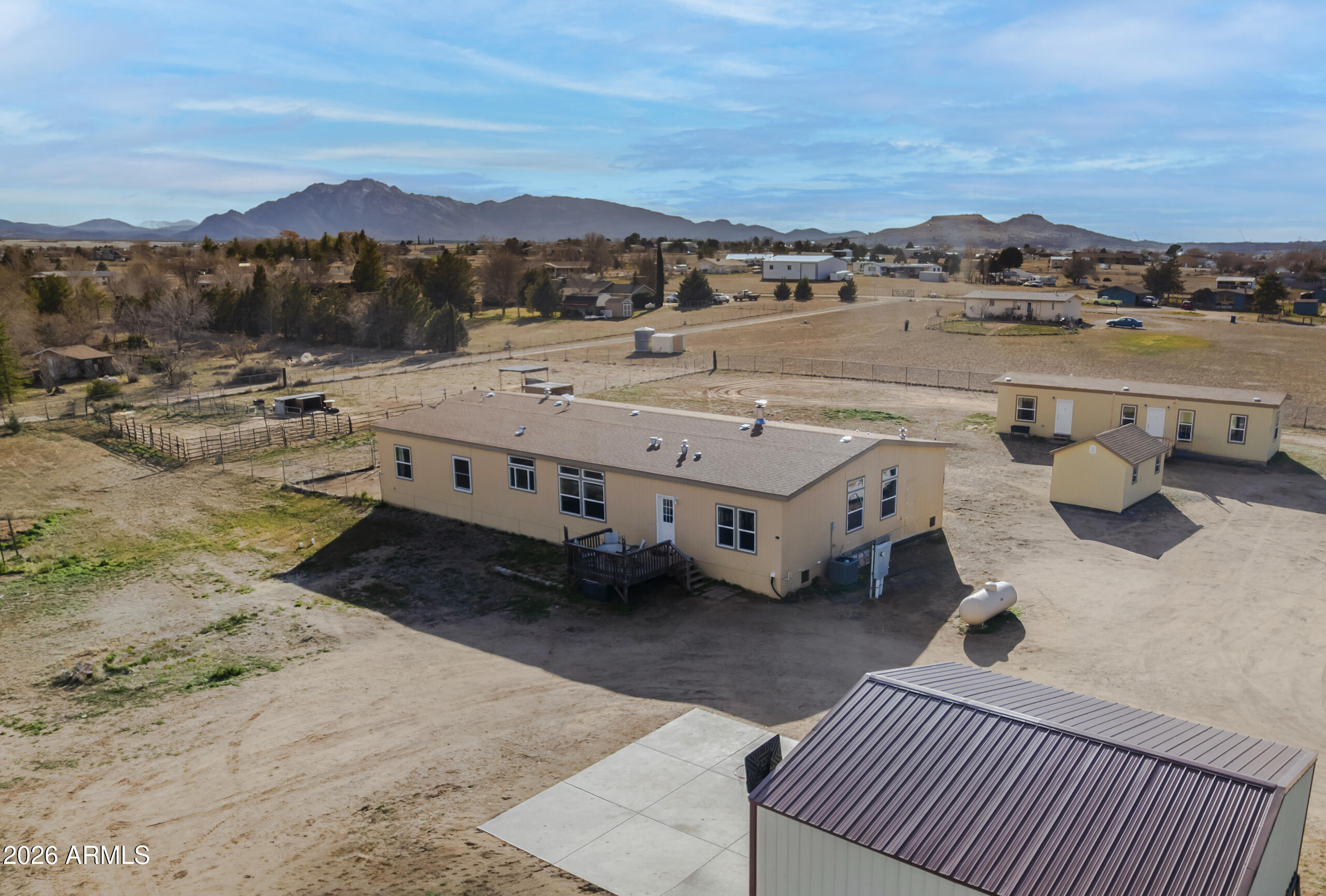 NEW SIDING AND FRESH PAINT 2026, securing long term value for you and minimizing maintenance needs for years to come!

Buyer changed their mind - Their loss is your gain!

Welcome to this exceptional Chino Valley property offering space, flexibility, and self-sufficiency on 2.56 fully fenced acres. The main home, installed in 2018, features an expansive 2,976 square feet with 4 bedrooms, 3 bathrooms, 2 family living areas (Living room and Family Room) and a bonus room, while the separate guest home--installed in 2020--adds an additional 832 square feet, ideal for multi-generational living or rental income. The property is thoughtfully equipped with a private well, two septic systems, two propane tanks, and RV hookups--perfect for gues travel enthusiasts, or additional flexibility. A 24x24 two-car metal garage provides ample room for vehicles, storage, or a workshop. Property is well laid out for farm animals, has a separately fenced backyard for dogs, and multiple enclosures for large animals. One enclosure includes shaded overhead cover. With open land and multiple living options, this property presents a rare opportunity for a mother-in-law setup, income-producing rental, or peaceful rural living, all while enjoying the charm and convenience of Chino Valley.