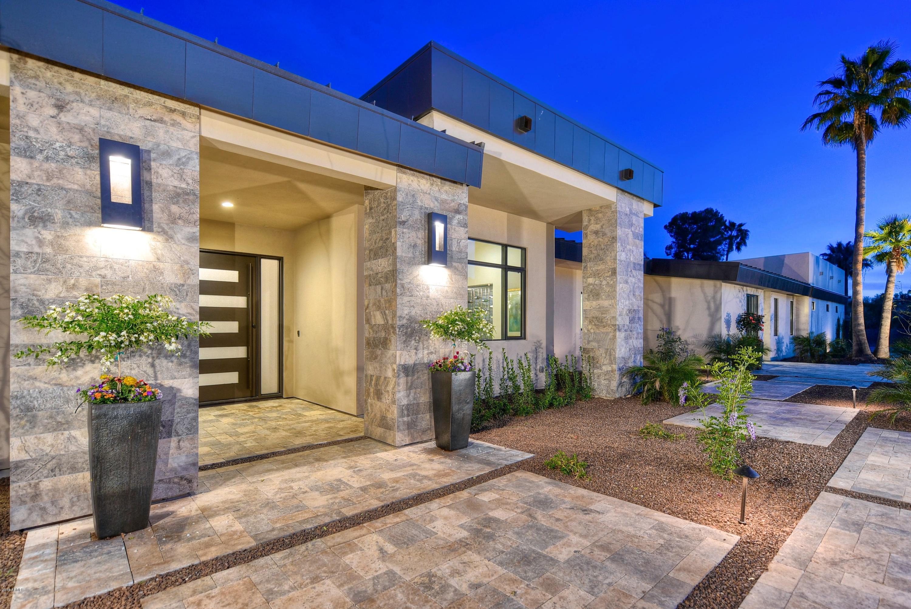 NEW BUILD 6714sf contemporary tucked into a quaint street with views to Mummy Mtn. Generous open concept showcases a great room with soaring ceilings, transom windows, fireplace, wine wall, and disappearing glass wall to the outdoor living space. Large chefs kitchen includes Wolf/Subzero appliances, quartz slab countertops, and hand crafted cabinetry. Large master suite presents amazing mtn views and spa like master bath with freestanding tub. 3 secondary ensuite bedrooms adjoin a separate flex room, ie: game/media/children's space. When guests arrive, show them to their own integrated guesthouse with additional family room, full kitchen, bedroom, and ensuite bath. Exterior spaces include large covered patio/entertaining space, gazebo with fireplace, heated pool/spa, and outdoor kitchen