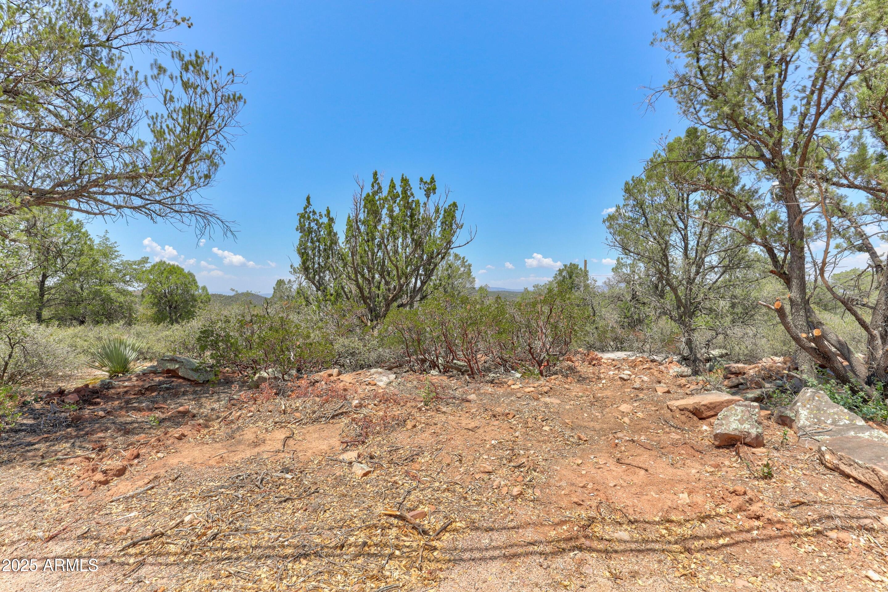 1.32 Acre lot in town above Green Valley Park with views. This lot is suitable for a one level home with a flat driveway and amazing views off the back deck with plenty of privacy and no HOA.  It is rare to find a lot for a single story home with a flat driveway with these kind of views.