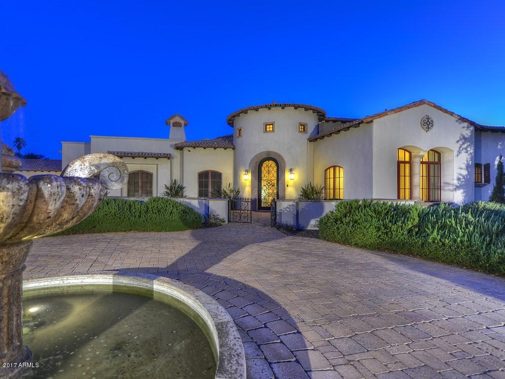 Huge Price Reduction! Spectacular Santa Barbara style home on quiet North South facing CDS lot in the heart of Paradise Valley steps away from the new Ritz Carlton. Circular drive w/fountain leads to gated motor court with 8 car air conditioned garage.This 6B split/7BA house has an appealing open floor plan and amazing curb appeal. Furniture Quality Rysso Peters Cabinetry in kitchen, laundry room, closets and office set the stage for a warm sophisticated family and entertaining home. Gourmet kitchen has Viking appliances and double islands. Oversized master suite has fireplace w/ huge, custom closets, his/hers bath areas, elegant office. Pella Windows, Creative Sound full home automation with Crestron, Lutron & Plasmas TV's throughout. Oversized Laundry w/island. Separate GH w/ fully equipped kitchen/living room. Billiards room, bonus room. Both FR & LR w/ fplcs
Resort style backyard has a 2000 sq.ft pool, oversized spa, large misted patio, built-In BBQ, and exterior Fireplace. Fully equipped theater. Pella Architectural series windows and safe room. 180 degree views of Camelback & entire Mummy Mtn. Range make this one of a kind home a must see!!!