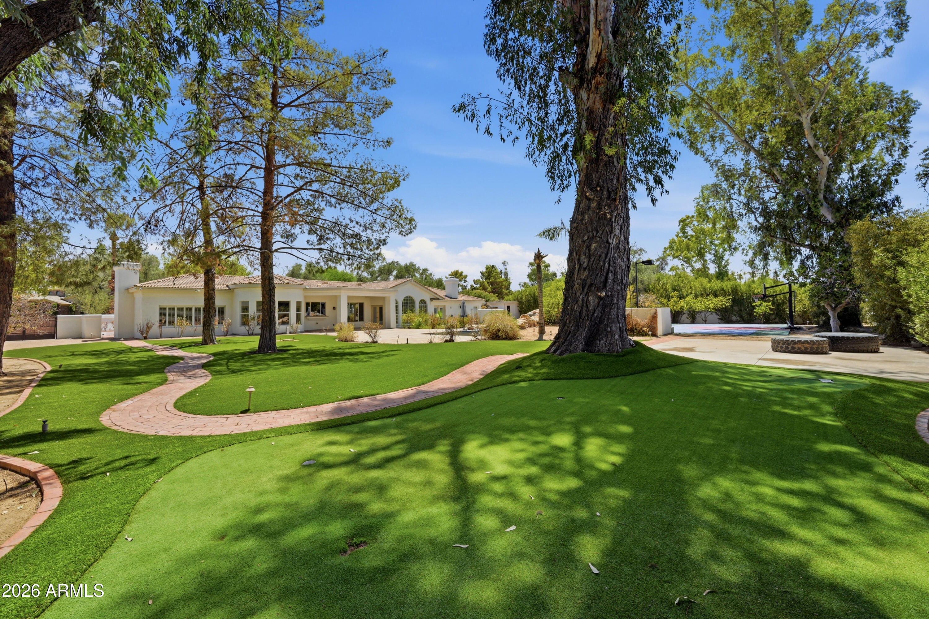Rare opportunity in coveted Paradise Valley Farms, perfectly positioned between Paradise Valley and Scottsdale's McCormick Ranch. Situated on an expansive 0.82-acre north/south-facing lot, this fully fenced estate with front gates offers exceptional privacy, a large motor court, RV gate, and room for multiple vehicles, boats, or an RV.

The home features 5 bedrooms, 3 bathrooms, a private guest suite with separate entrance, dedicated office, formal living and dining rooms, and an open kitchen overlooking the family room. Outside, enjoy a resort-style backyard with a pebble-finish pool and waterfall, spa, built-in BBQ, firepit, putting green, and lighted sport court for basketball, pickleball, or tennis.

Surrounded by luxury homes in one of Scottsdale's most desirable and appreciating neighborhoods, this property presents an incredible opportunity to renovate, reimagine, or build long-term equity. Perfect for buyers looking to customize their dream home, investors seeking value-add potential, or developers searching for a premier lot. No HOA, located within the award-winning 3 C's school district, and just minutes from golf, lakes, dining, and shopping. Priced in line with a recent $3.3M appraisal.