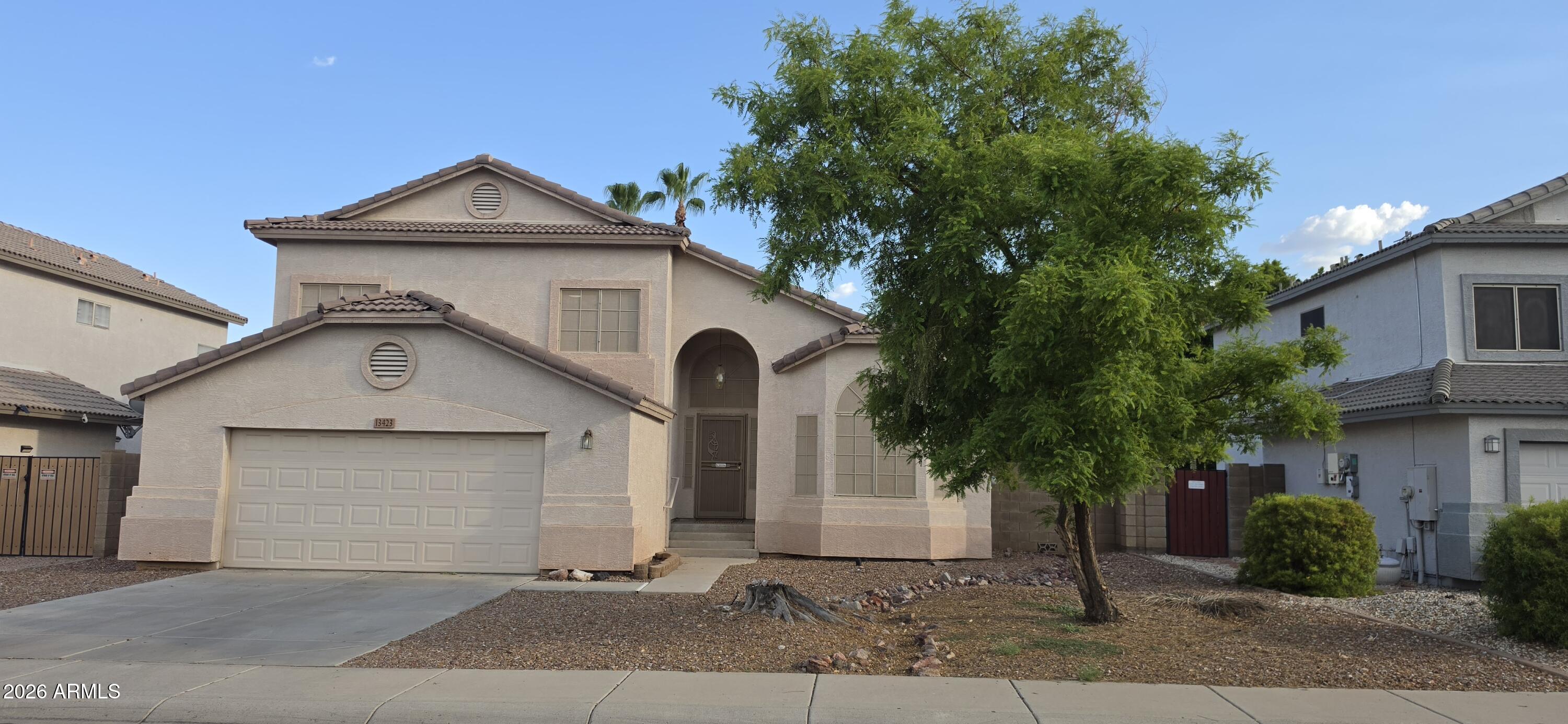 Beautiful two-story home featuring soaring vaulted ceilings, abundant natural light, and an open floor plan perfect for everyday living and entertaining. The kitchen boasts a large center island, stainless steel appliances, a tile backsplash, and modern dark cabinetry. The spacious backyard is a blank canvas ready for the next owner to create their dream outdoor oasis. Enjoy existing features including a covered patio, built-in gas fire pit, and an extra-large gas brick pizza oven--perfect for entertaining family and friends.
