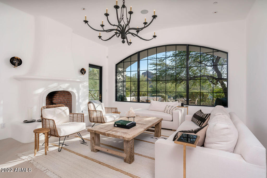 A uniquely tasteful ''lock 'n leave'' home with a crisp, clean Santa Barbara aesthetic was fully remodeled in 2019 by acclaimed designer Matthew Boland and GM Hunt. Located on one of PV's most desired streets with bold views of both Camelback & Mummy Mtn, the tranquil setting includes a private gated driveway, lush desert landscaping, trickling water features and several outdoor seating areas. The interior finishes are fresh & bright w/ bleached white Oak & limestone flooring, exquisite custom lighting, steel doors & windows, reclaimed Belgian iron gates and a German-engineered kitchen by Leicht w/ Miele appliances. The floor plan offers flow & flexibility for both intimate family gatherings and entertaining.