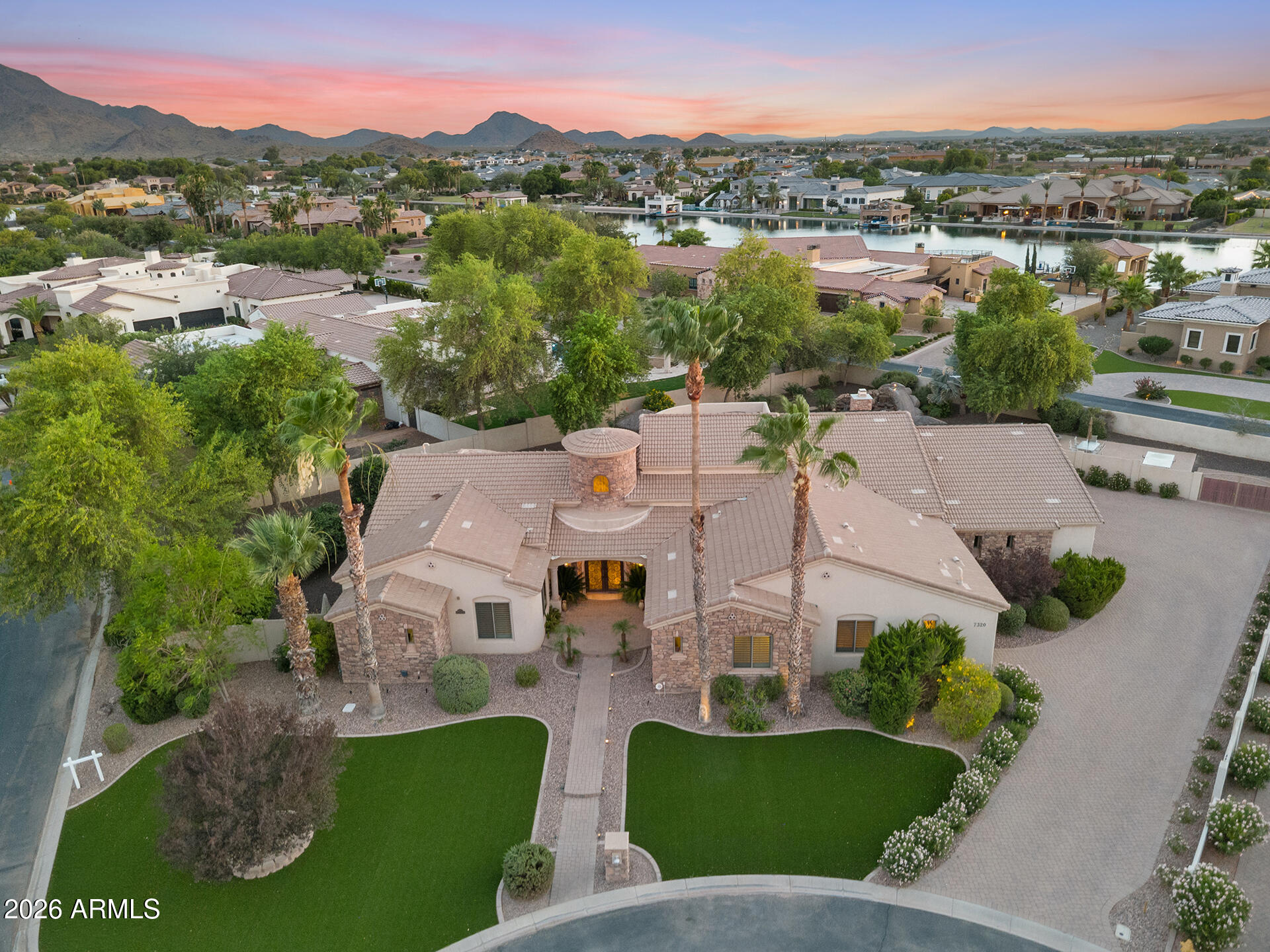 PURE LUXURY--WHERE EFFICIENCY, SPACE, AND STYLE COME TOGETHER! Nestled on an impressive 0.6+ acre corner lot in an exclusive gated community, this extraordinary estate offers 4,587 sqft of upscale living space, owned solar, and breathtaking views of the San Tan Mountains!

Designed for both comfort and sophistication, this 5-bedroom home features 4 full bathrooms and 2 half baths. Four of the bedrooms have their own en-suite bathrooms and walk-in closets. This home includes an attached mother-in-law suite with a private entrance and full bathroom--perfect for guests, multi-generational living, or extended stays. 

The stunning curb appeal sets the tone with elegant pavers, a wrought-iron entry door, and extensive professional landscaping with artificial turf to reduce water bills. Inside, soaring coffered ceilings, travertine flooring, a central vacuum, and a striking stone fireplace create an atmosphere of timeless luxury.

The chef-inspired kitchen showcases custom cabinetry, granite countertops, a wine fridge, a warming oven, a pot filler, and a beverage fridge, all while having abundant space for entertaining. Step outside to a true resort-style backyard with two palapas, a large pool with a slide and a waterfall, and an in-ground trampoline.
There are community parks nearby and mailboxes across the street. This lot is very private!

Completing the package is a spacious 4-car garage in an exceptional location within a prestigious gated community. Offering luxury, functionality, energy efficiency, and spectacular mountain views. This remarkable property delivers the lifestyle you've been dreaming of.
