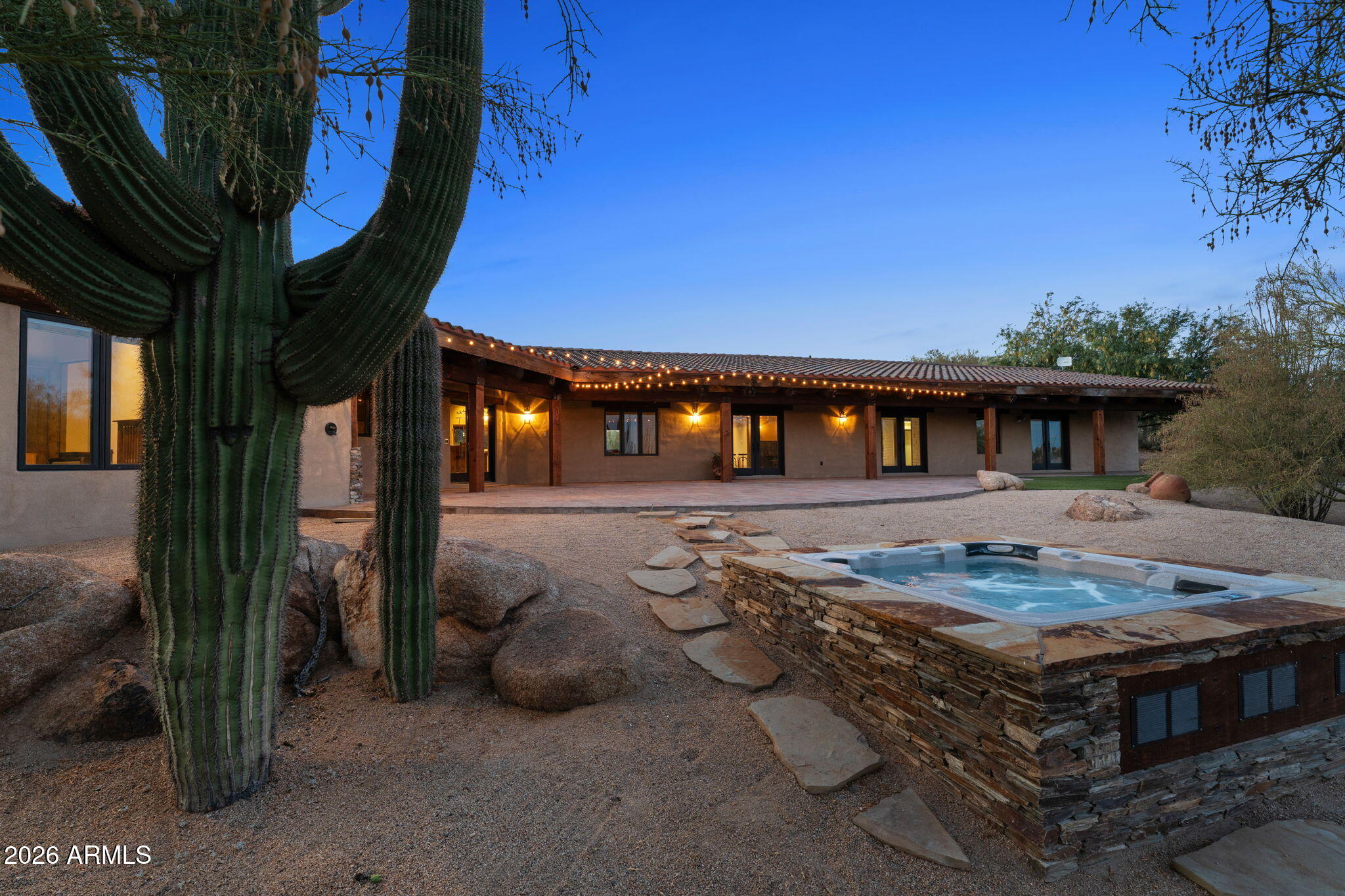 Horse enthusiasts and car collectors, this is your DREAM property! Located on 15+ acres in one of Wickenburg's most desirable areas, few properties offer this combination of quality construction and infrastructure, direct trail-riding access, extensive shop facilities, RV amenities, and one-of-a-kind views overlooking Blue Tank Wash Canyon. Accessed by a private paved road and located just minutes from town, this 3-bedroom, 3.5-bath property was thoughtfully designed for horse enthusiasts, car collectors, RV owners, gardeners, pet lovers, and those seeking an exceptional Arizona lifestyle. Inside, exposed beams and tongue-and-groove ceilings showcase the craftsmanship found throughout the home. Granite countertops, custom cabinetry, and authentic Mexican tile complement the thoughtful design and quality materials used throughout the residence. Careful attention to detail creates a home that is both inviting and enduring. Expansive wraparound front and back porches embrace the property's rustic ranch character and create exceptional indoor-outdoor living and entertaining spaces. A rock-edged spa overlooks the surrounding desert landscape and takes full advantage of the breathtaking views into Blue Tank Wash Canyon, providing the perfect setting to relax and enjoy Arizona's spectacular sunsets and star-filled skies. The horse amenities include covered stalls, a turnout, arena, tack room, hay and tractor storage, direct trail access, and no-climb perimeter fencing. Riders can leave directly from the property and access nearby trails without ever loading a trailer, making it easy to enjoy the surrounding desert and canyon landscape on horseback. The professionally designed, fully insulated, climate-controlled shop is a true car collector's dream and equally well suited for recreational vehicles, hobbies, or equipment storage. The 4,225 sq foot facility features heating and air conditioning, two 9,000-pound two-post lifts, an office, one full bathroom, one half bathroom, dedicated 200amp electrical service, oversized 14-foot RV doors, and a dedicated septic system. Far more than a detached shop, it offers the scale, infrastructure, and versatility rarely found in a private residence. Three full RV hookup locations provide exceptional flexibility for your recreational vehicles and visiting guests. For those who enjoy gardening, pets, and outdoor living, the property also features a fully fenced raised-bed garden with automatic irrigation and shade structures, creating an ideal environment for year-round growing. Mature citrus trees enhance the landscape and provide seasonal harvests, while a spacious dog run offers a secure area for four-legged family members. These thoughtful additions further enhance the property's versatility and unmatched functionality. Professionally landscaped grounds complete a property developed with both purpose and practicality in mind. This is a rare opportunity to own a property that combines luxury living with outdoor enjoyment.