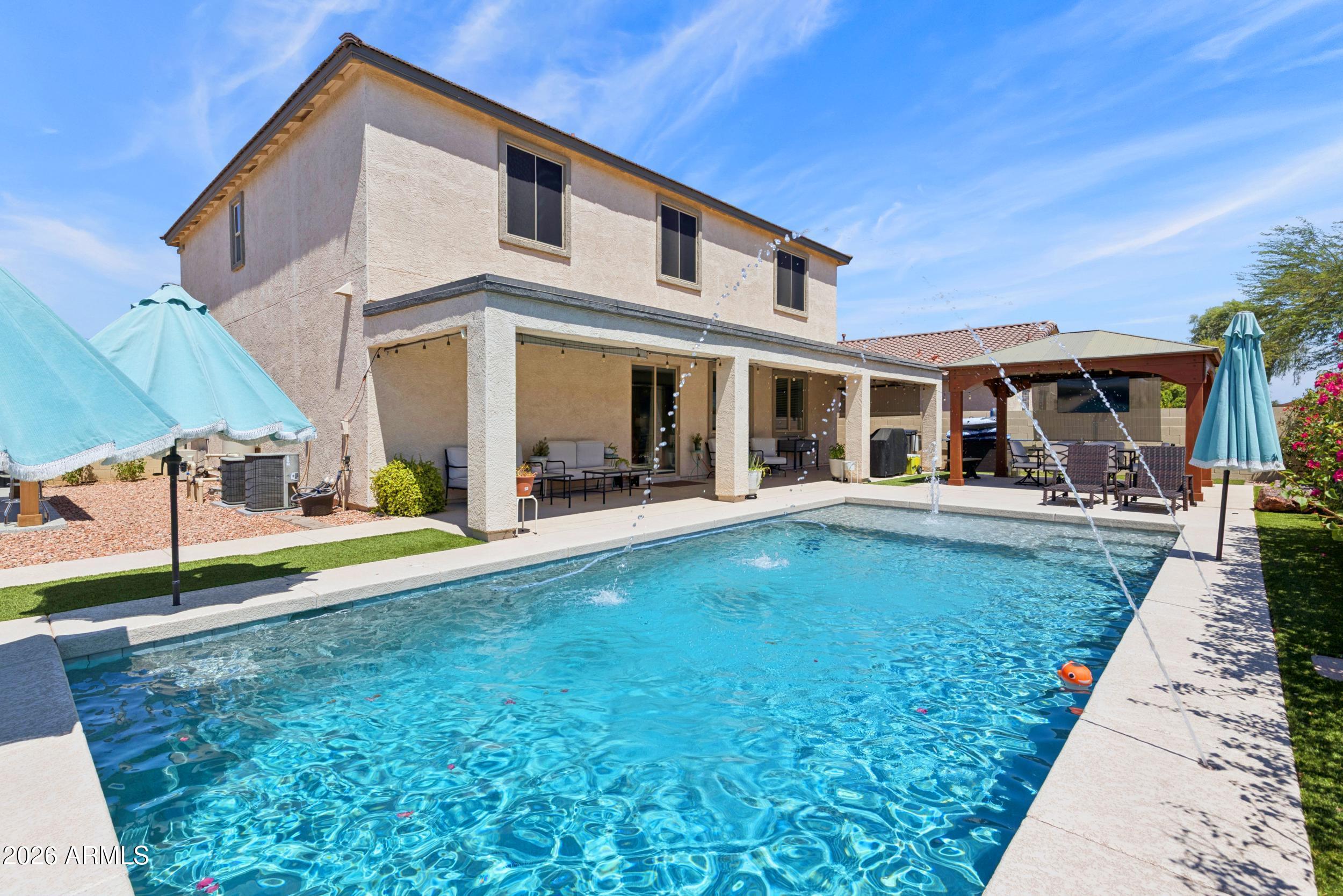 Welcome to your own private retreat in the heart of Goodyear! This beautifully maintained
5bedroom, 3bath home offers 3,238 sq. ft of spacious living on an oversized 10,000+ sq. ft. corner lot with no neighbors behind. 
The resort-style backyard is designed for entertaining, featuring a sparkling 3year old pool with a Baja shelf, basketball hoop, two gazebos, and plenty of space to relax or host family and friends. Inside, you'll find an open-concept floor plan with luxury vinyl flooring throughout the main living areas, a spacious kitchen that flows into the living and dining areas, and a downstairs bedroom with a full bath perfect for guests or multi-generational living. Upstairs offers a large primary suite, three additional bedrooms, a full bath, and an oversized loft. The 3-car garage includes a dedicated mini-split A/C unit, making it an ideal workshop, home gym, hobby space, or climate-controlled storage.
Conveniently located just minutes from I-10, Loop 303, Goodyear Civic Square (GSQ), shopping, dining, parks, and entertainment. Community amenities include a pool, recreation center, and more.

Don't miss this exceptional opportunity!