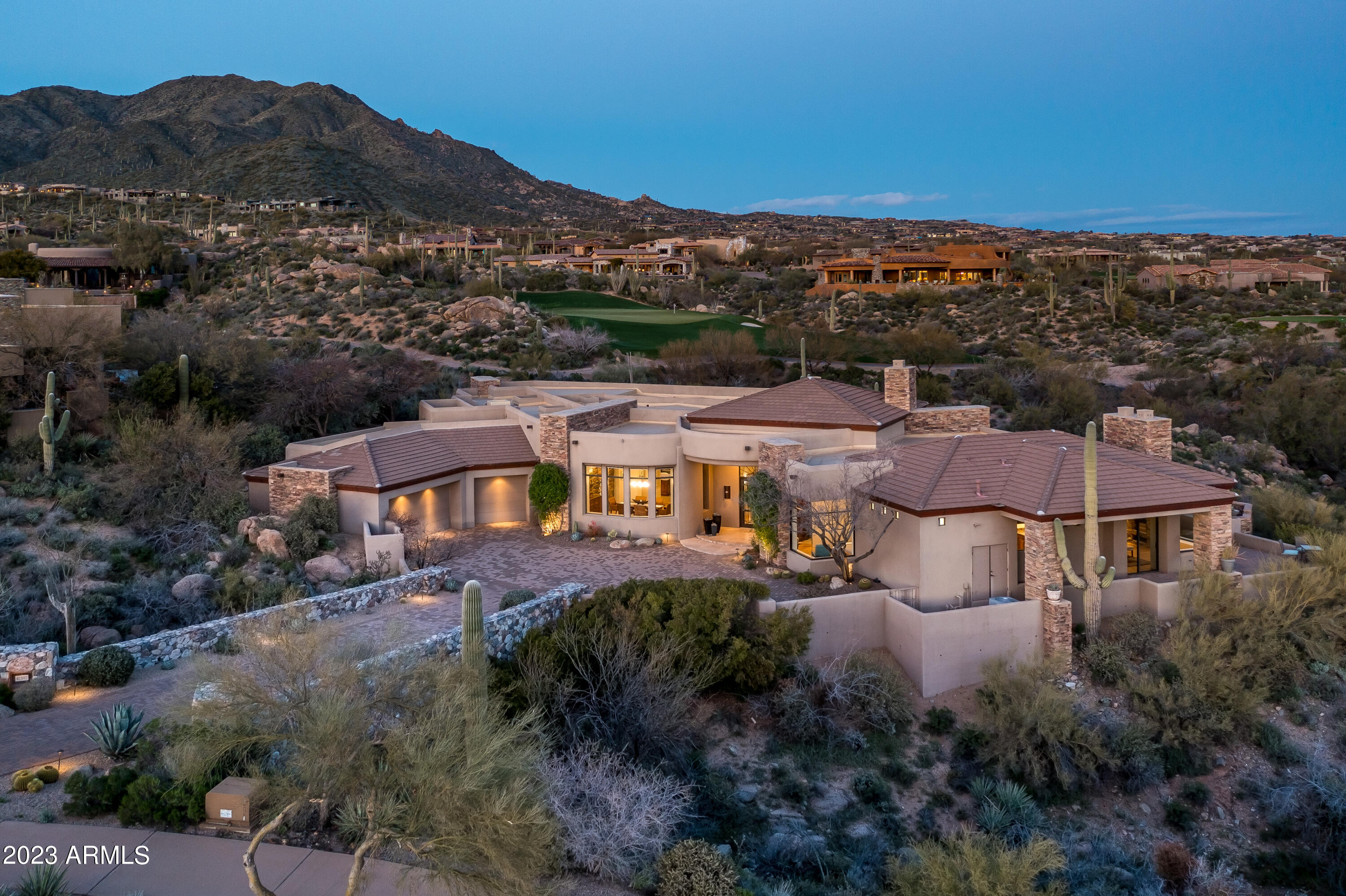 Timeless open floor plan, light and bright Desert Contemporary located in the Village of Saguaro Forest. The Full golf membership is available to transfer at close of escrow with a 30  day pre approval from the Desert Mountain Club. Picture perfect view of the 8th hole of the Chiricahua golf course as well as sunset, city light and mountain views.Desirable open floor plan is perfect for entertaining with a disappearing wall of glass flowing out to the resort like patio with pool/spa, fire pit, & outdoor kitchen. The home is all on one level-Living room, dining room, kitchen, family room, wet bar, large wine room, large master suite and 3 additional guest en-suites with a large den or office, 4 car garage. Everything you need to enjoy the Desert Mountain Lifestyle!