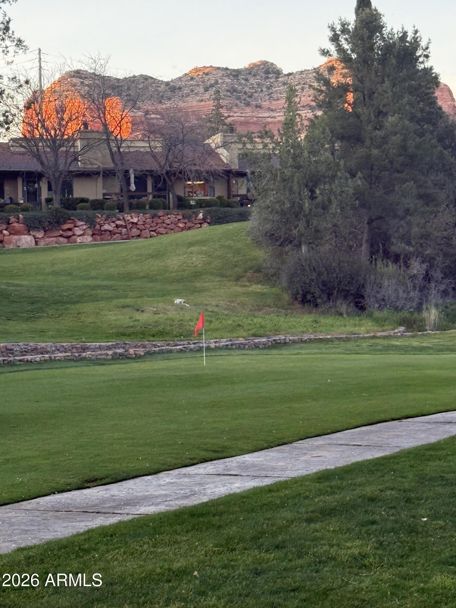 GOLF COURSE LIVING + SHORT TERM RENTAL READY!
Rare opportunity to own a turnkey retreat in the gated Canyon Mesa Country Club, where Short Term Rentals are permitted! This isn't just a home; it's an all-access pass to the Sedona lifestyle. Situated directly on the 2nd fairway, you'll enjoy stunning golf course and mountain views right from your front Trex deck.
The Value: Your HOA isn't just a fee--it's a savings plan. It covers roof repair/replacement, exterior maintenance, sewer, trash, and unlimited golf for owners. Inside, find a modern-southwest aesthetic with Brazilian granite countertops, travertine flooring, and a cozy wood-burning fireplace. Both bedrooms offer private patio access, perfect for starlit Sedona nights. This fairway gem delivers all what you are looking for. Nestled within the gated Canyon Mesa Country Club & perfectly positioned along the 2nd fairway, this single level, beautifully updated Sedona townhome offers refind living surrounded by lush green fairways and tranquil water features. The thoughtfully designed 1,068 sq ft interior features two bedrooms & two bathrooms, enhanced by elegant travertine flooring, granite Brazilian granite, & stainless steel appliances. The living room's wood-burning fireplace adds warmth & character, creating an inviting space for relaxation & entertaining. Both bedrooms open directly to a private back patio.  A cozy front, easy to maintain Trex deck provides stunning views of the golf course & fountain-perfect for enjoying Sedona's sunsets.