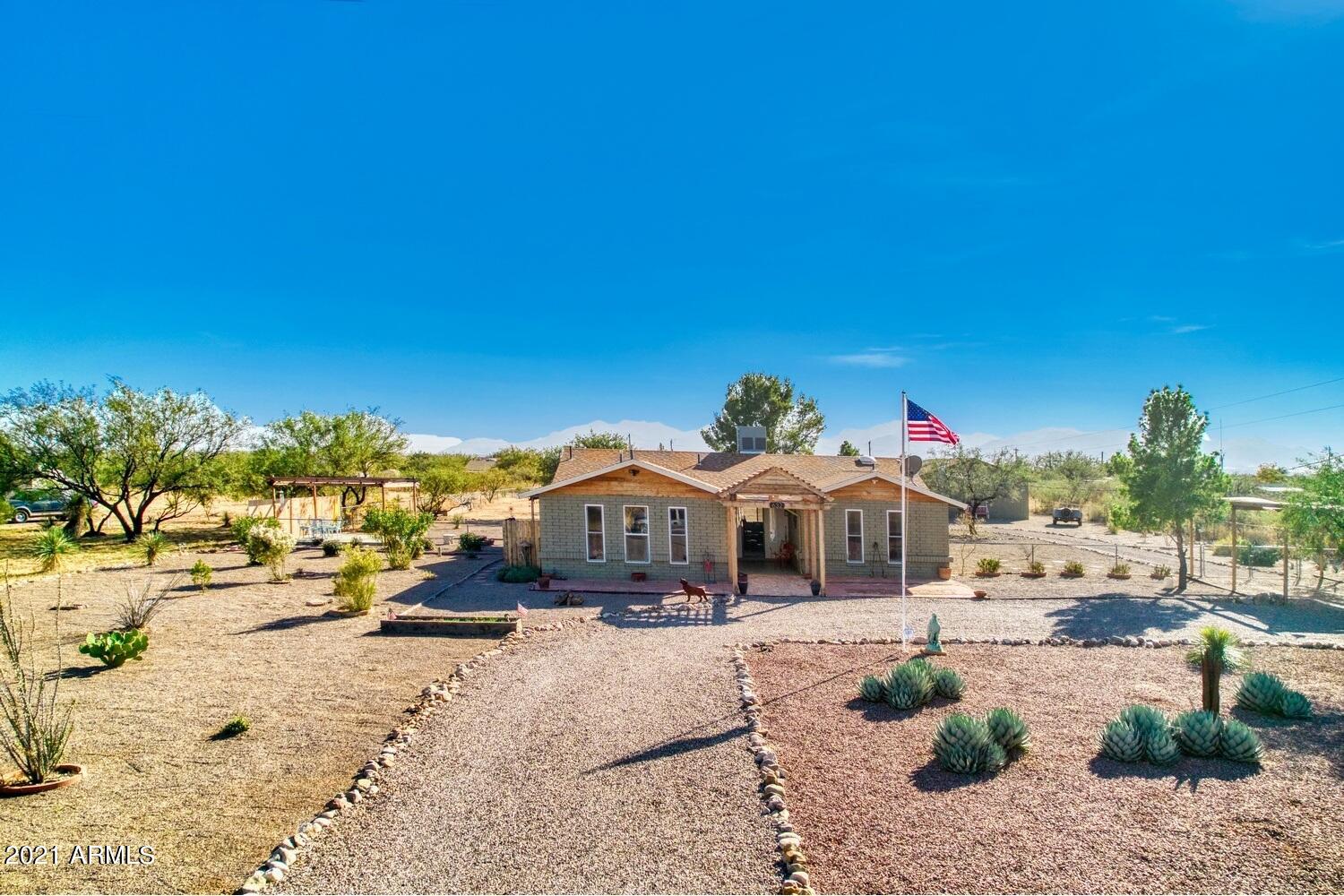 What a property!  This home sits on approximately 1.5 fully fenced acres and has been remodeled and loved!  3 bedrooms 2 GORGEOUS bathrooms appointed with all the extras and special touches.  This home is completely tiled so no fear in bringing the critters!  Every room in the home has so many special touches, but not over stated!  Large living area with gorgeous views.  Unbelievable remodeled kitchen with upgraded appliances and quartz countertops.  The garage was converted into a huge bedroom which could be the master, with special touches you don't want to miss!  Outside is an enormous 4 car garage/workshop that is almost every man's dream! This home will be gone in the blink of an eye, so don't miss your chance to see it for yourself.  Call today for your private showing.