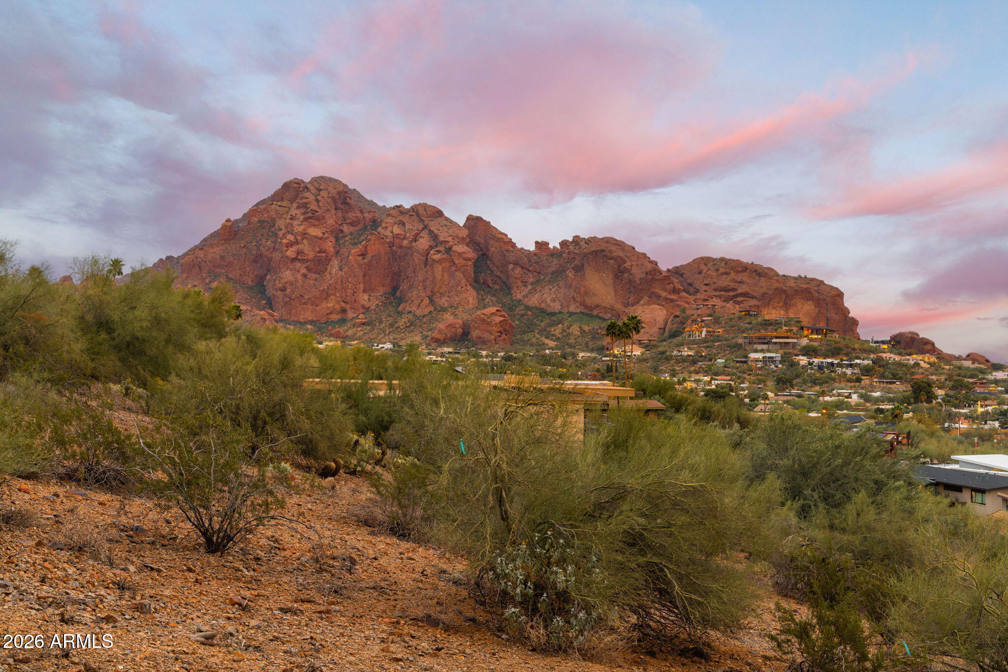 This hillside parcel on Piestewa Peak offers commanding, unobstructed views directly to Camelback Mountain, Praying Monk, and the downtown Phoenix skyline--one of the most recognizable view corridors in the Valley. Unlike raw hillside dirt, this offering includes fully approved architectural plans by Kendle Design Collaborative and an issued permit--allowing a buyer to bypass Hillside and Town of Paradise Valley review and save more than two years in timeline. The proposed modern estate is designed to step naturally with the terrain, maximizing sightlines, privacy, and seamless indoor-outdoor living. From the elevated pool deck and primary living spaces, Camelback becomes a framed focal point--an iconic backdrop that commands premium pricing and buyer demand.