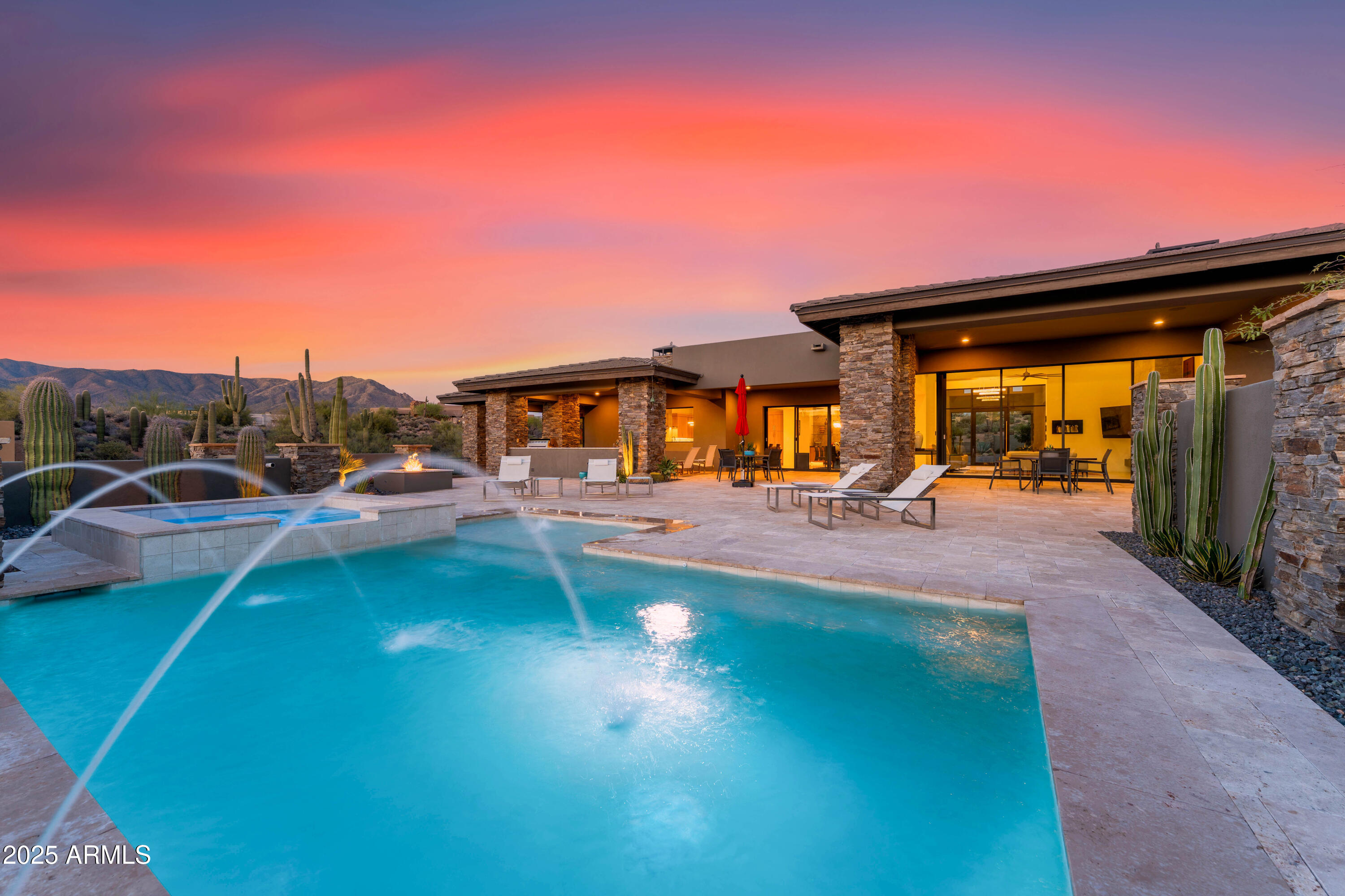 This stunning Desert Mountain contemporary home with Lifestyle Membership is walking distance to the Sonoran Club House. 
The open floor plan features an expansive great room, 18 ft ceilings, and  dramatic sleek stone hearth. The massive chef's kitchen has top appliances, generous storage and 2 oversized islands. The large format porcelain tile throughout; floor to ceiling glass, stone and metal all combine to create a dramatic, inviting atmosphere. A unique split floor plan features 3 ensuite bedrooms plus study with the lavish primary suite encompassing its own private wing. Two oversized garages provide ample 4 car parking with room for storage. The exterior landscape has recently been updated by one of Scottsdale's foremost Landscape architects. Arizona Resort Living at its finest! The dramatic panoramic Mountain Views, large covered patios, music using the Control4 Smart Home sound system, huge built-in outdoor barbecue, pool, fire pit and spa all add to the entertaining ambiance. The furniture, furnishings and art are all available (turnkey including kitchen set-up and bed/bath linens!) under separate bill of sale. Personal items list provided by Seller. Don't miss this entertainer's dream home!