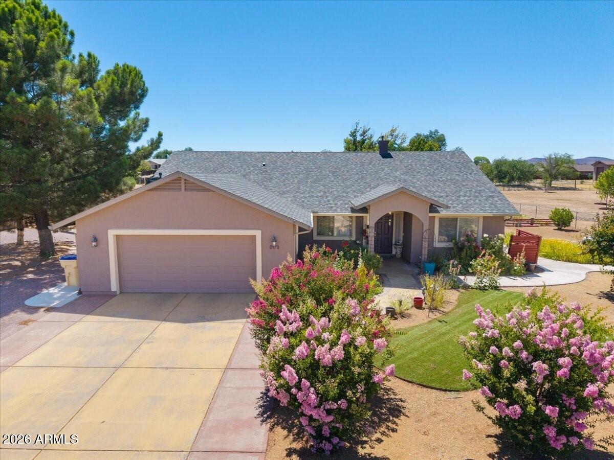 This beautifully maintained single-story ranch, built in 2004, offers 1,502 square feet of comfortable living on a full one-acre parcel. The home features both a private well and city water -- the well is primarily used for drip irrigation to keep those beautiful gardens thriving. Outside is an absolute paradise -- a stocked pond with fish and a beautiful waterfall, a relaxing hot tub, gorgeous flower gardens in both the front and back, and plenty of space to enjoy it all. Inside, you'll love the cozy pellet stove for supplemental heat, plus a whole-home fire suppression system for added peace of mind. Perfect single-level home with incredible outdoor living on a full acre. Come see it for yourself!