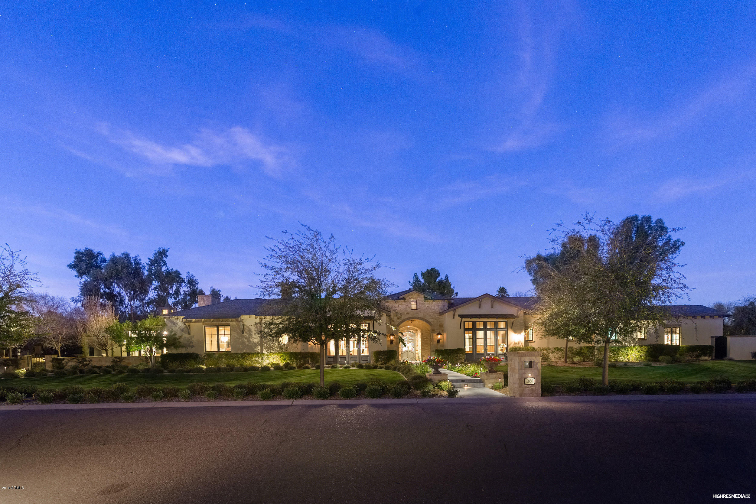 Inspired by the Chateau's of France and Italy, this sophisticated and luxurious retreat reflects the magical merging of inspiration and architecture. Created by renowned architect Mark Candelaria and custom home builder John Schultz, this estate is a masterpiece of design and craftsmanship featuring Landscape design and install by Berghoff, and Interior Design by Caroline De Cesare. Interior finishes boast: Craftsman Court tiles from Portugal and Spain, Steel doors that provide an expanse of light and allow the outdoors in, custom designed light fixtures crafted by Hinkley's Lighting, expansive zinc bar w/bi-fold windows, 10 ft. bi-fold doors that open to the charming covered patio, antique Limestone fireplace surrounds and antique panels from the Paris market. Mater Suite features his/her closets, with washer dryer, soaking tub w/heating element and large steam shower. Kitchen is wonderful and full of natural light, has a large walnut topped center island, 2 dishwashers, 36" refrig. & 36" freezer, loads of cabinets and deep drawers by Desert Cove Cabinetry. The adjacent butlers pantry features a steam oven and another Sub Zero back up refrigerator along with ice maker and large pantry. From the rift cut White Oak floors to the brushed Limestone baths no detail has been missed. Exterior features include; gas lanterns, exterior powder room, Indian Blue Limestone on patios, Texas Limestone meandering walls, large grassy areas, exterior fire pit, Koi Pond, and Citrus gardens. This is a smart home wired by Cyber Tech equipped with the Savant Home Automation System. Oversized 4 car garage with a workshop and large air-conditioned storage room all tucked away behind private gates. Don't miss the stunning garage doors, acid stained garage floors or the Copper Cupola's adorning the slate roof. This is one you don't want to miss!!!!