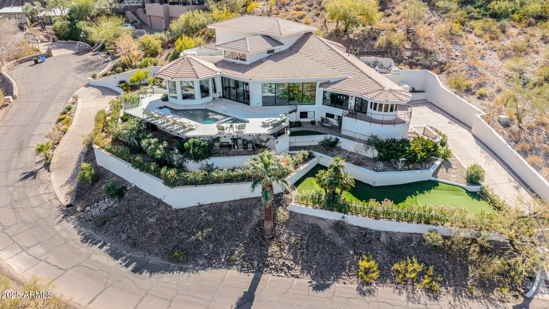 *BEST VALUE ON CAMELBACK MOUNTAIN Only $551 Sq Ft* Perched atop the prestigious head of Camelback Mountain, this private, gated estate offers an unparalleled blend of luxury, privacy, & breathtaking vistas. No HOA. Rarely do homes with views this extraordinary become available. Gaze at Mummy Mountain, Piestewa Peak, & Paradise Valley's sparkling city lights, or enjoy iconic Arizona sunsets & the famous Praying Monk from the home & its outdoor entertaining spaces. Renovated with over $1M in upgrades, this 6-bedroom, 6.5-bathroom estate includes an office, two flex spaces, 3.5-car garage, & a new elevator. The stunning pool & hot tub feature sleek glass fencing, preserving the panoramic vistas. Minutes from top dining, shopping, golf, & Sky Harbor Airport, this is a one-of-a-kind retreat.