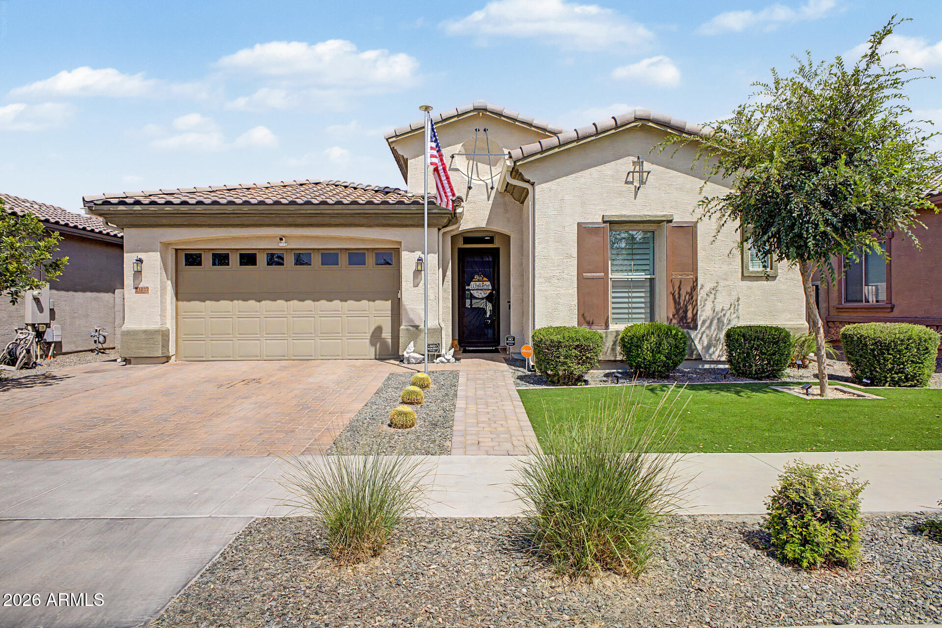 Located in Harvest Queen Creek, this beautifully maintained 4-bedroom, 3-bath home with a den and 3-car garage offers the space, function, and community lifestyle buyers are looking for. The open-concept layout features high ceilings, recessed lighting, neutral finishes, and stylish wood-look flooring throughout the main living areas.

The kitchen is the heart of the home with quartz countertops, white shaker cabinetry, stainless steel appliances, decorative tile backsplash, walk-in pantry, and a large island with breakfast bar seating. The flexible den sits behind sliding barn doors and offers direct access to the covered patio and turf area, making it ideal for a home office, lounge, playroom, gym, or retreat.

Two secondary bedrooms are connected by a Jack-and-Jill style bathroom, w the spacious primary suite offers plantation shutters, dual sinks, and a generous walk-in closet. Outside, enjoy a covered patio, paver patio space, and low-maintenance landscaping.

Harvest Queen Creek offers community amenities including a pool, lake, playgrounds, community spa, and biking/walking paths. Close to Downtown Queen Creek, Schnepf Farms, Queen Creek Olive Mill, and San Tan Mountain Regional Park, this home delivers the right mix of space, upgrades, and lifestyle.