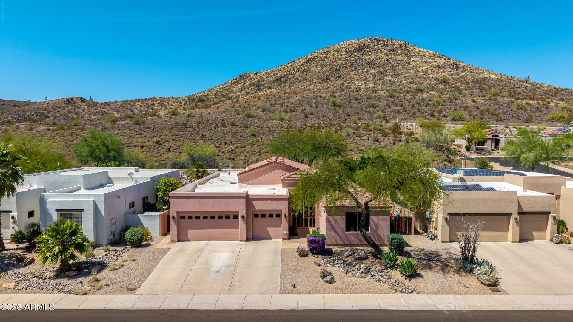 Nestled on a premium hillside lot in the highly sought-after Arrowhead community, this single-level home offers a resort-style backyard with a spool, waterfall, firepit, and breathtaking mountain views--perfect for relaxing or entertaining. Enjoy peace and serenity while still being close to everything! Major updates provide peace of mind, including newer A/C units (2023 & 2024), newer roof, and water heater (2022). The desirable split floor plan features 3 bedrooms plus a den, 2.5 bathrooms, and a spacious 3-car garage, all surrounded by natural beauty in a golf course community near top-rated schools, parks, shopping, and quick access to the Loop 101. Inside, you'll find vaulted ceilings, abundant natural light, and tile throughout the main living areas. The updated kitchen showcases soft-close cabinetry, granite countertops and backsplash, stainless steel appliances (refrigerator included), recessed lighting, a large granite composite sink, and a pantry. Bathrooms feature granite countertops, custom tiled showers, and framed mirrors. The primary suite offers private patio access, mountain views, a jetted tub, skylight, double sinks and two closets. Step outside to your private backyard retreat with flagstone patio, outdoor speakers and lighting, mature desert landscaping, three sliding doors to the patio, and a gas fire pit with built-in seating. The spool has been recently updated with new PebbleTec, tile, and pump. Additional highlights include surround sound in the living and family rooms, washer and dryer less than a year old, sunscreens, fresh exterior paint (2025), long driveway, double side gate, storage cabinets in the garage, and an electric vehicle charger (220V). Homes like this rarely come available, don't miss your opportunity!