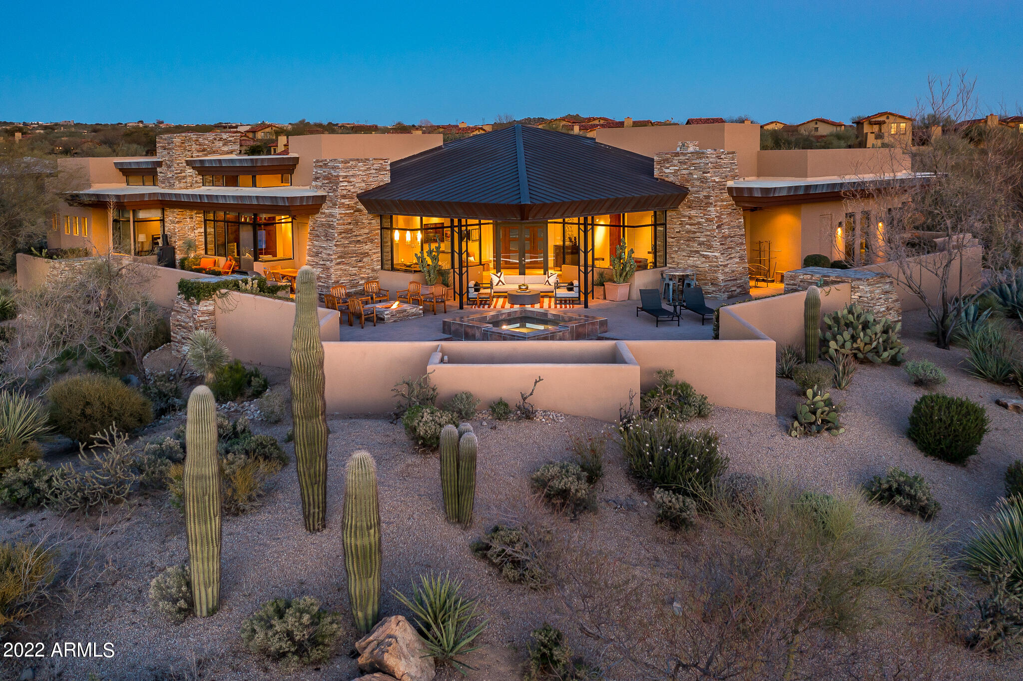Lifestyle membership available. Designed by architect Erik Peterson and built by Platinum Homes, this Frank Loyd Wright inspired soft contemporary home in Scottsdale, Arizona's Desert Mountain is perfectly placed on the lot to ensure privacy & capture the outstanding views from every room. A mahogany front door opens to the central living & dining area, with its copper-clad fireplace & a panoramic mountain view. A vaulted cedar ceiling extends from the interior to the patio overlooking the pool, spa and firepit.   Ideal split floor plan with three suites, study with built in bookshelves and desk on one side of the home and owners suite on the other side.  Kitchen offers Sub Zero and Wolf appliances, and opens to a cozy hearth room with another copper clad fireplace.  Truly a must see.