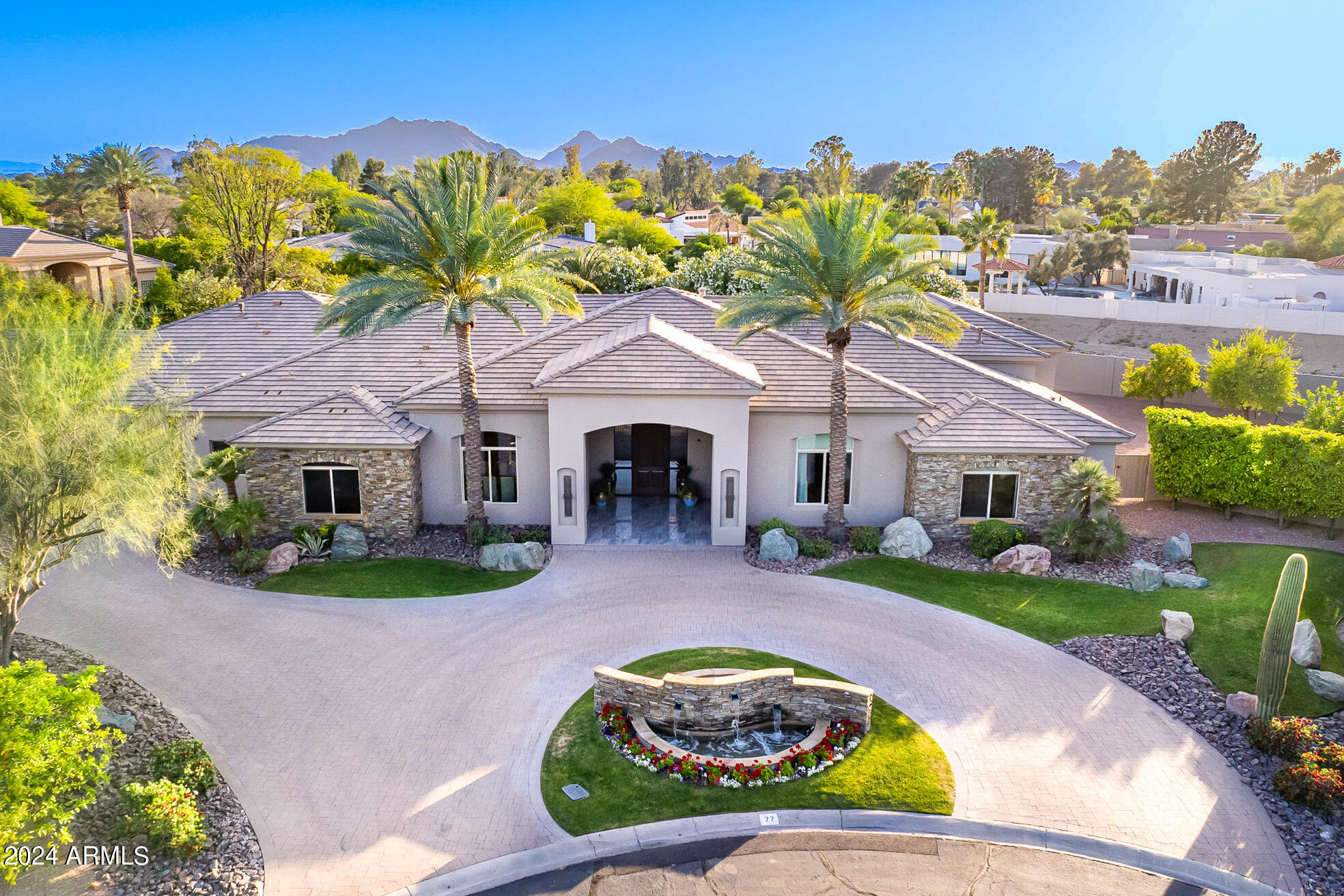 Nestled within the prestigious guard-gated enclave of Equestrian Manor, this majestic residence spans an impressive 6155 square feet, showcasing a seamless blend of design and enduring sophistication. With 4 bedrooms, 7 baths, and 3 fireplaces every facet of this home exudes refined opulence.
Step into a world of unrivaled splendor as the seamless integration between indoor and outdoor spaces invites you to immerse yourself in the enchanting open-air ambiance. The family room gracefully transitions into an adjoining game room, featuring a sleek bar and a multi-screen television wall, all seamlessly controlled by your integrated Control 4 system. With automatic retractable glass doors and an expansive outdoor patio area, this sanctuary offers an immersive luxury living experience at every turn. Venture outdoors to discover a tranquil oasis where lush landscapes and dramatic boulders create a captivating backdrop for outdoor entertainment. Enjoy the meticulously designed outdoor amenities, including a pristine putting green, a sleek linear fire pit, a built-in BBQ, and enchanting pots of fire with mesmerizing water spillways cascading over the azure pool.
Unleash your culinary prowess in the heart of this home - a sophisticated European-style kitchen adorned with every conceivable comfort and cutting-edge appliance. Whether hosting grand soirées or relishing intimate family gatherings, this culinary haven is sure to inspire culinary excellence and unforgettable moments.
For the automotive aficionado, a sprawling 2400 square foot garage awaits, capable of accommodating 8 to 10 vehicles with ease, ensuring that your prized collection is housed in unparalleled luxury and security.
With its seamless integration of modern conveniences and effortless operation, this exceptional residence epitomizes luxury living at its zenith in the coveted enclave of Equestrian Manor. Don't miss the chance to claim this extraordinary property and elevate your lifestyle to unparalleled heights.