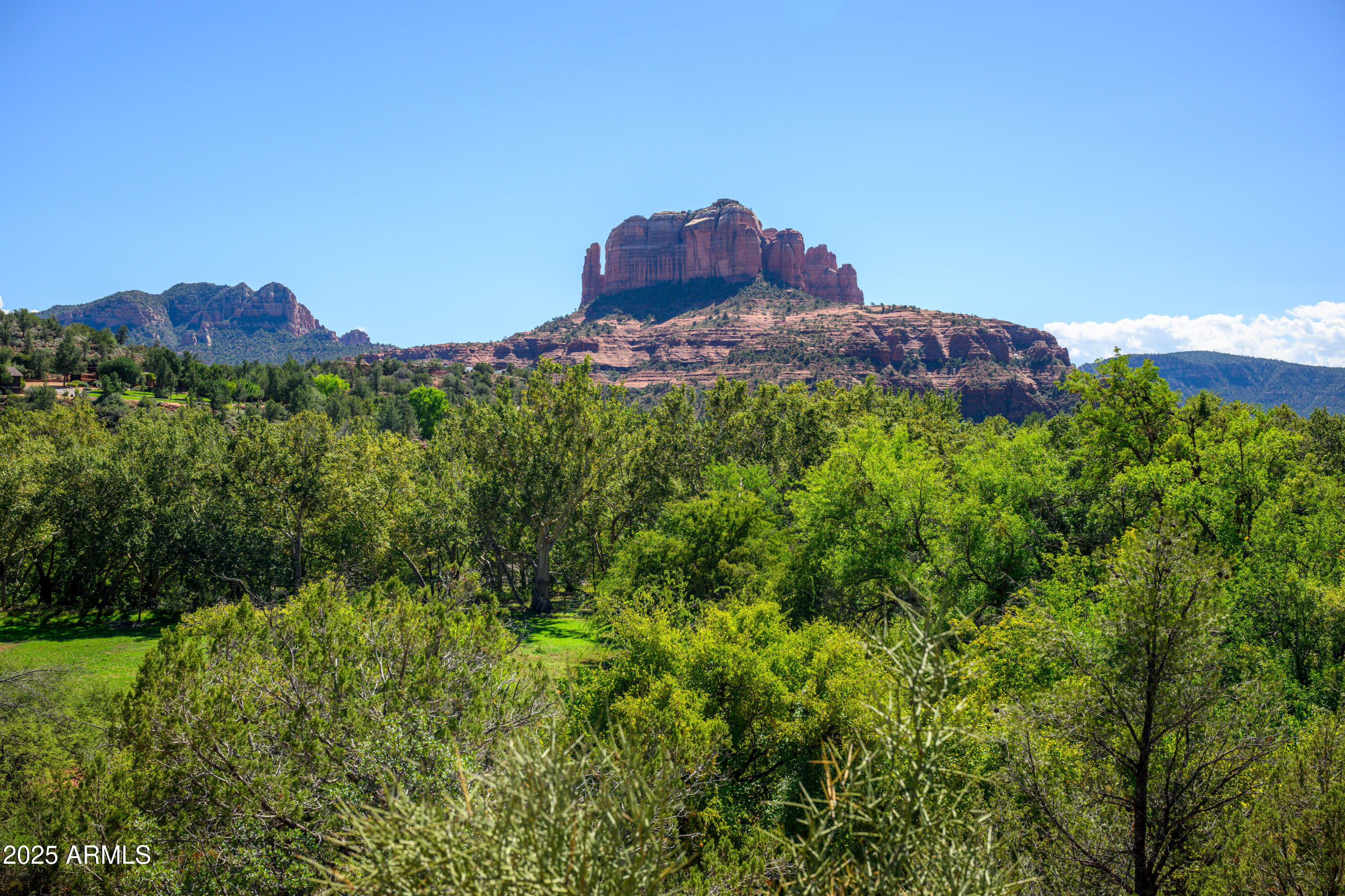 Scenic Sedona Sanctuary 1.7 Acre lot with Iconic Cathedral Rock Views and No HOA.

Discover this truly rare and inspiring vacant land opportunity tucked away off Chavez Ranch Road, a private hillside retreat that captures the essence of Sedona's natural beauty. This exceptional 1.7 acre homesite offers uninterrupted, direct views of Cathedral Rock, one of the region's most iconic and breathtaking formations. This property offers a unique canvas to bring your vision to life located in one of Sedona's best kept secrets of Chavez Ranch Road area.
Positioned on an elevated slope, the lot offers views over the lush green belt of Oak Creek, where the Red Rocks meet vibrant riparian greenery filled with resident wildlife and blooming plant life. The building envelope for your home can be thoughtfully designed into the upper portion of the mountainside to take full advantage of the elevation, privacy, and sweeping views or at the base of the property where an already constructed leveled homesite provides the ideal location for a tucked away living space. The lower portion is carefully constructed to allow for proper design of septic, water well, and home construction. Electricity is established on the lot and available to tie into.

With no homeowners association, you have the freedom to create without restrictive covenants and being located in Yavapai County there is no oversight from the City of Sedona. The property is just a short walk from the waters of Oak Creek, inviting you to enjoy swimming, fishing, or simply relaxing by the water. Outdoor enthusiasts will appreciate the proximity and walking distance to some of Sedona's best hiking trails, scenic viewpoints, and the quiet charm of Sedona's Red Rock living.
This land is more than a homesite, it is a rare opportunity to own a piece of Sedona's most magical landscape, where natural beauty, privacy, and possibility come together in perfect harmony.