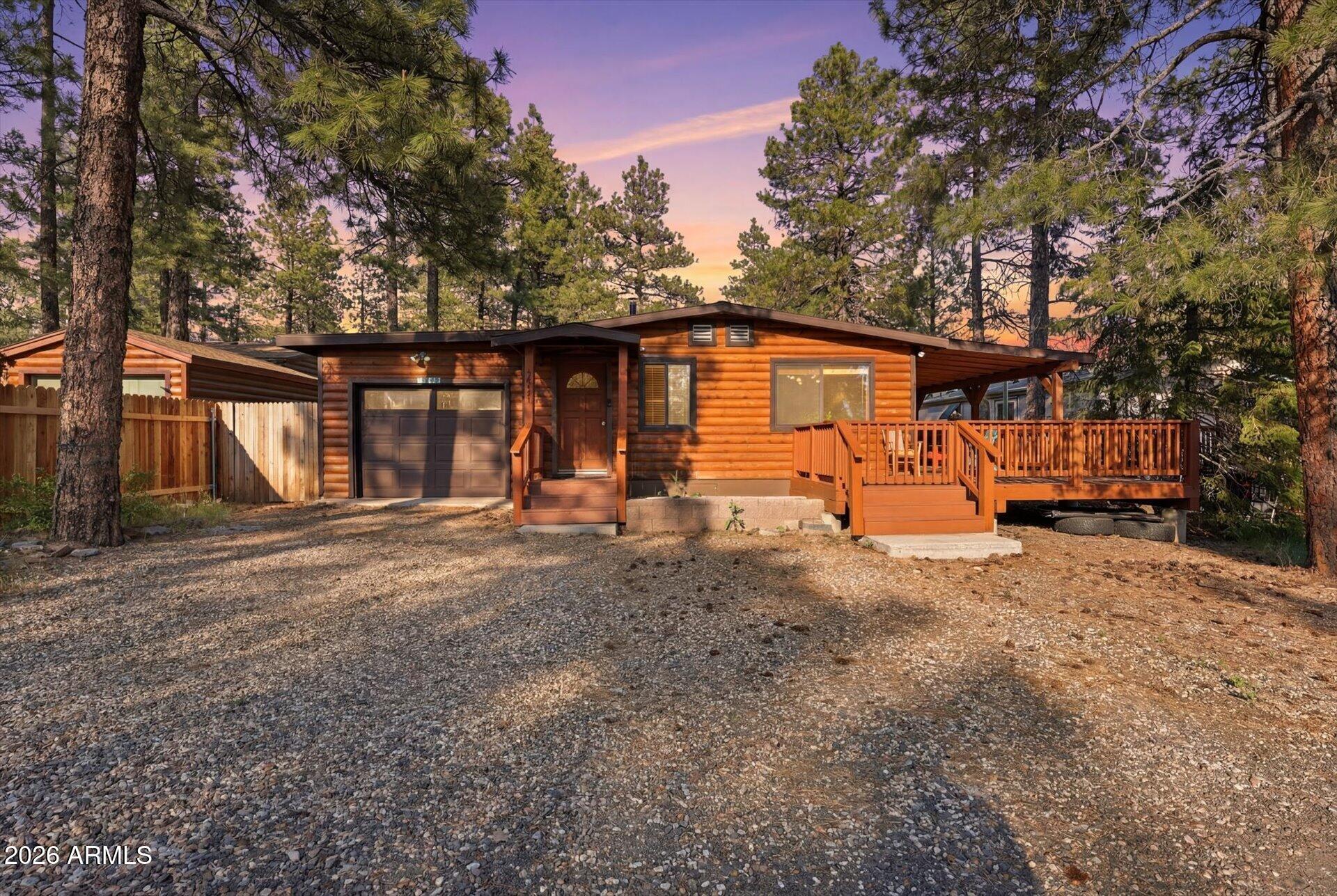 This log-sided home offers both character and comfortable living. The fully fenced backyard provides privacy and space for pets, play, or gardening. Enjoy relaxing or entertaining on the huge covered side deck, perfect for taking in the outdoors year-round. Additional features include a 1-car garage for convenient parking and extra storage and central air conditioning. A wonderful blend of warmth, functionality, and outdoor living!
