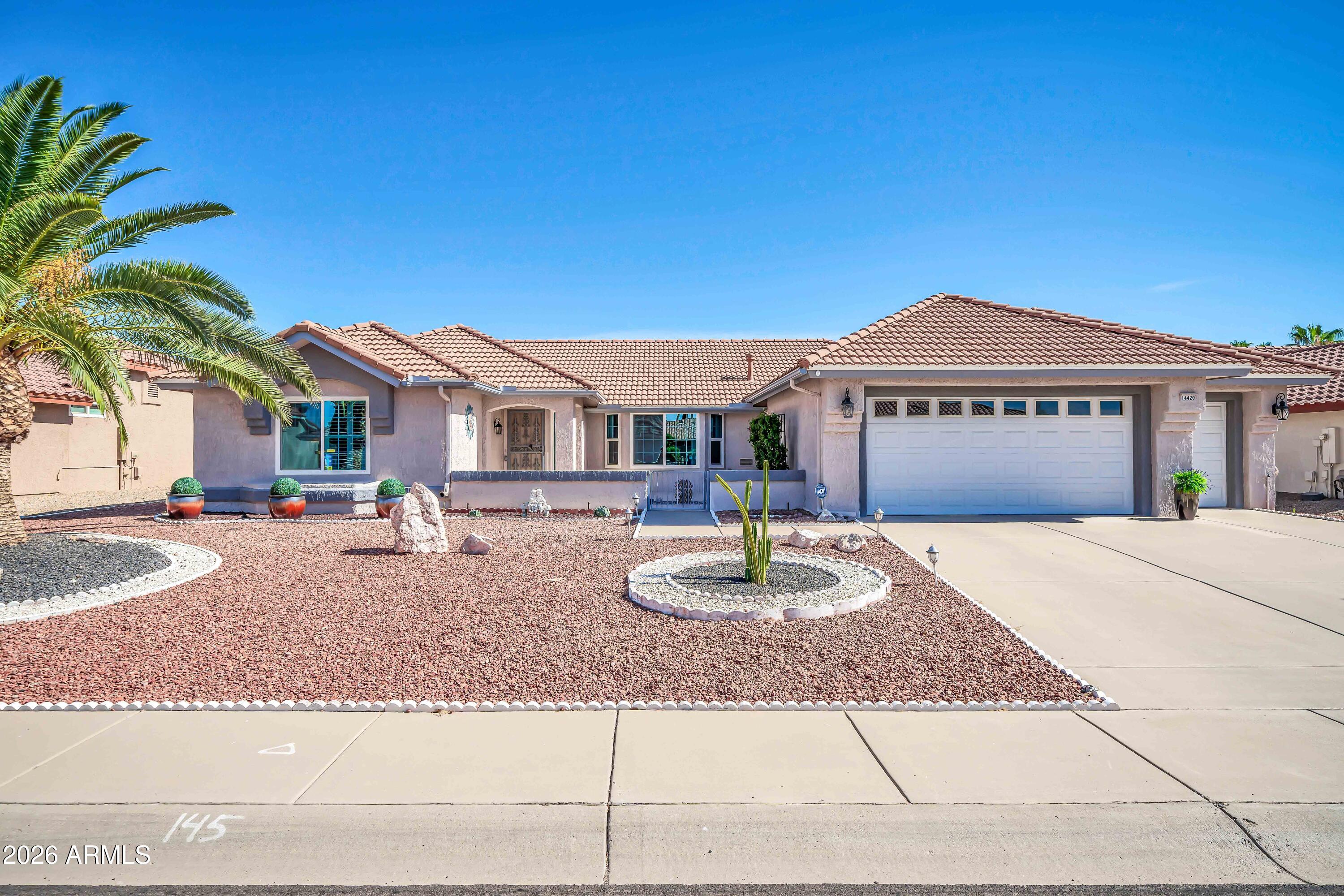 Pride of ownership shines throughout this thoughtfully updated home featuring a new roof 2025, front windows 2021, gutters, and a private front courtyard. Vaulted ceilings, diagonal tile, and decorative accents enhance the open living spaces. The refreshed kitchen includes a tile backsplash, 2023 refrigerator, updated hardware, and water filtration. A flexible bonus room with vaulted ceiling and patio access offers space for guests, hobbies, or media, plus a separate den/office. The primary suite features a bay window, walk-in closet, and updated bath with granite and raised vanity. A 2.5 Golf Cart garage provides extensive storage, workbench, insulated door 2022, and whole-house water filtration. Two patios, pergola, BBQ area, block wall, and a spacious yard complete the outdoor setting.